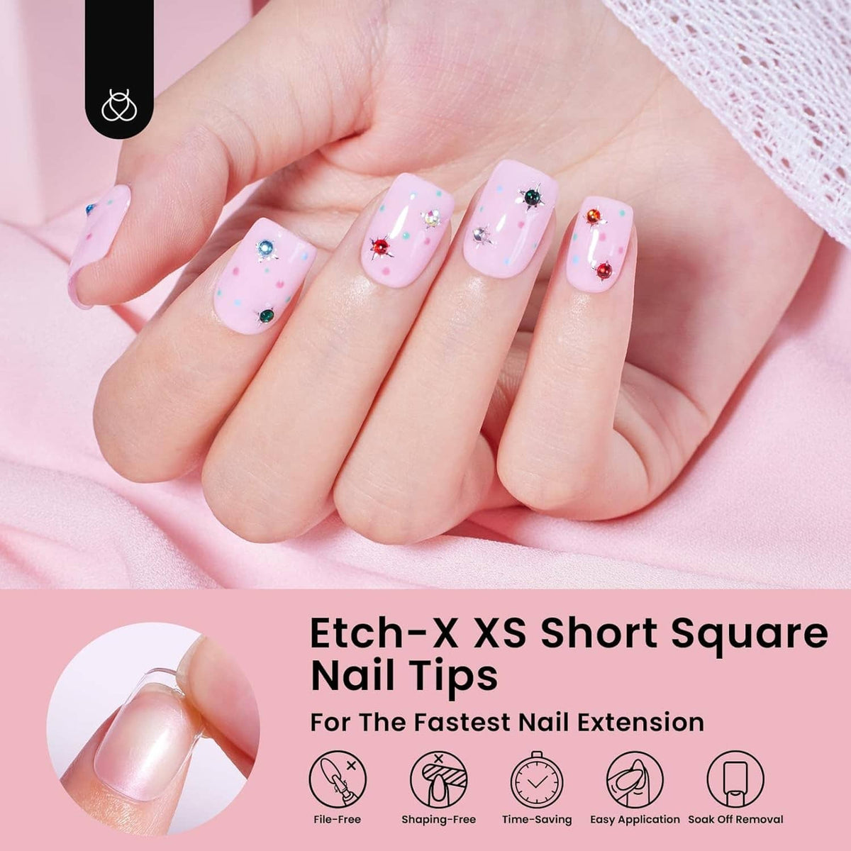 Decorated short square nail tips on fingers, pastel pink with small flower details