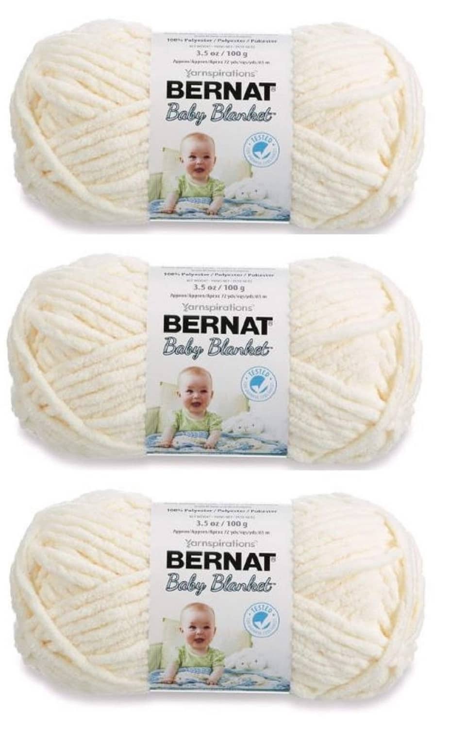 Bernat Baby Blanket yarn in Vanilla, three yarn skeins with packaging labels
