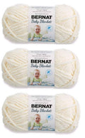 Bernat Baby Blanket yarn in Vanilla, three yarn skeins with packaging labels