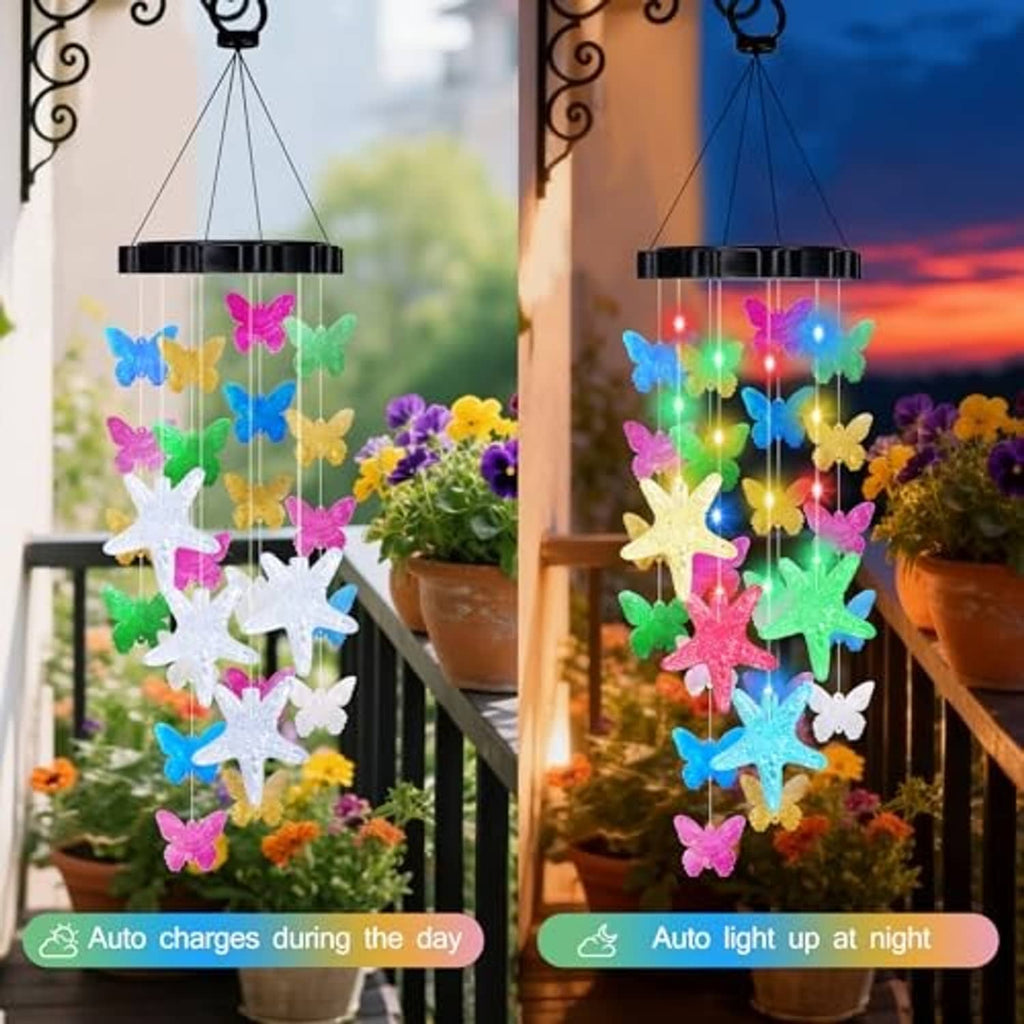 Solar wind chime with colorful butterfly and starfish shapes glowing at night