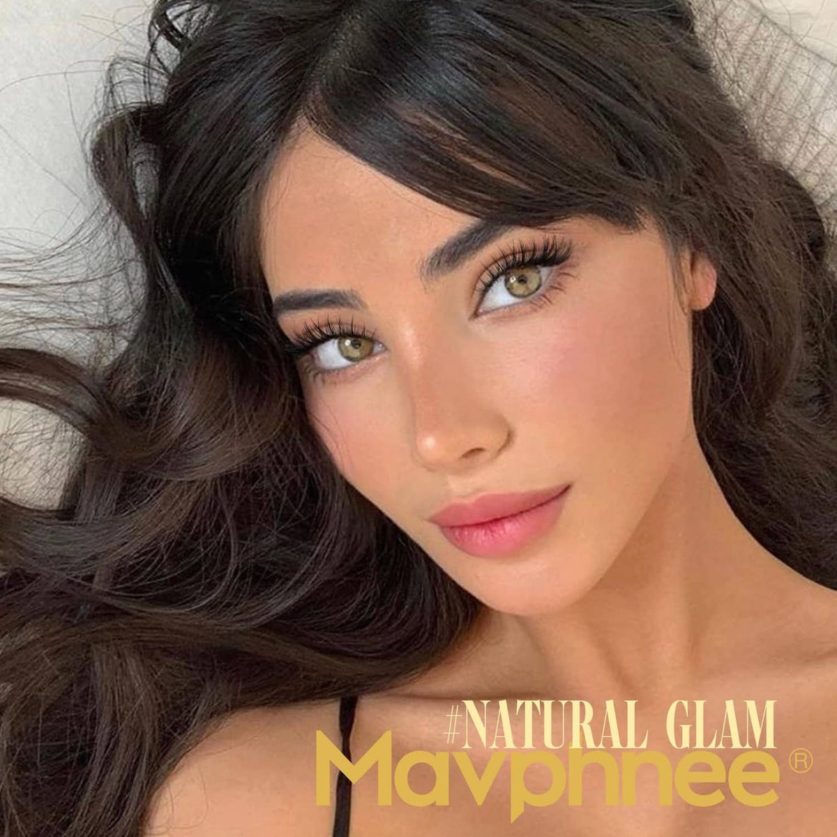 Model wearing black lash clusters with defined lashes and natural glam look