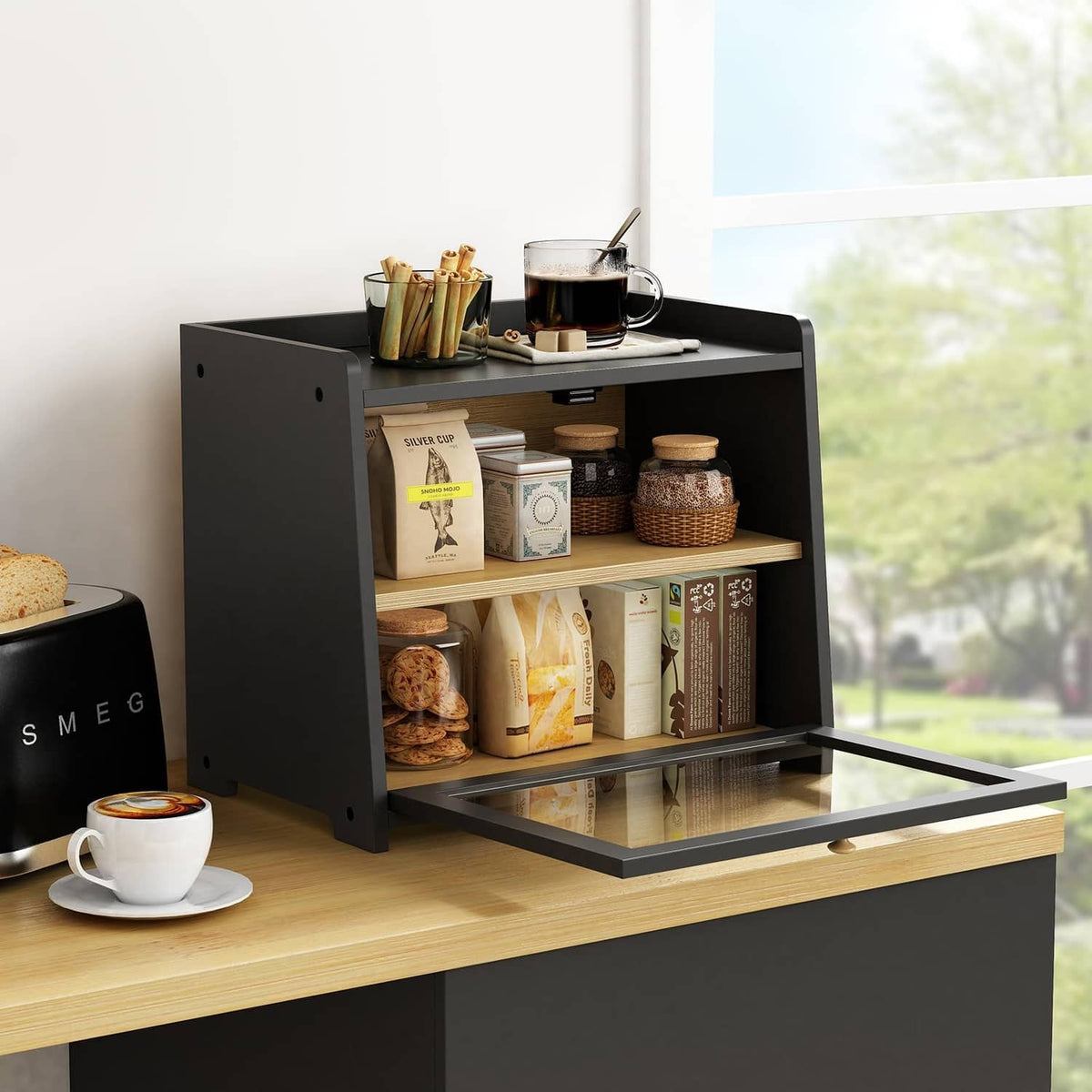 Black countertop bread box with open front and two shelves holding bread and pantry items