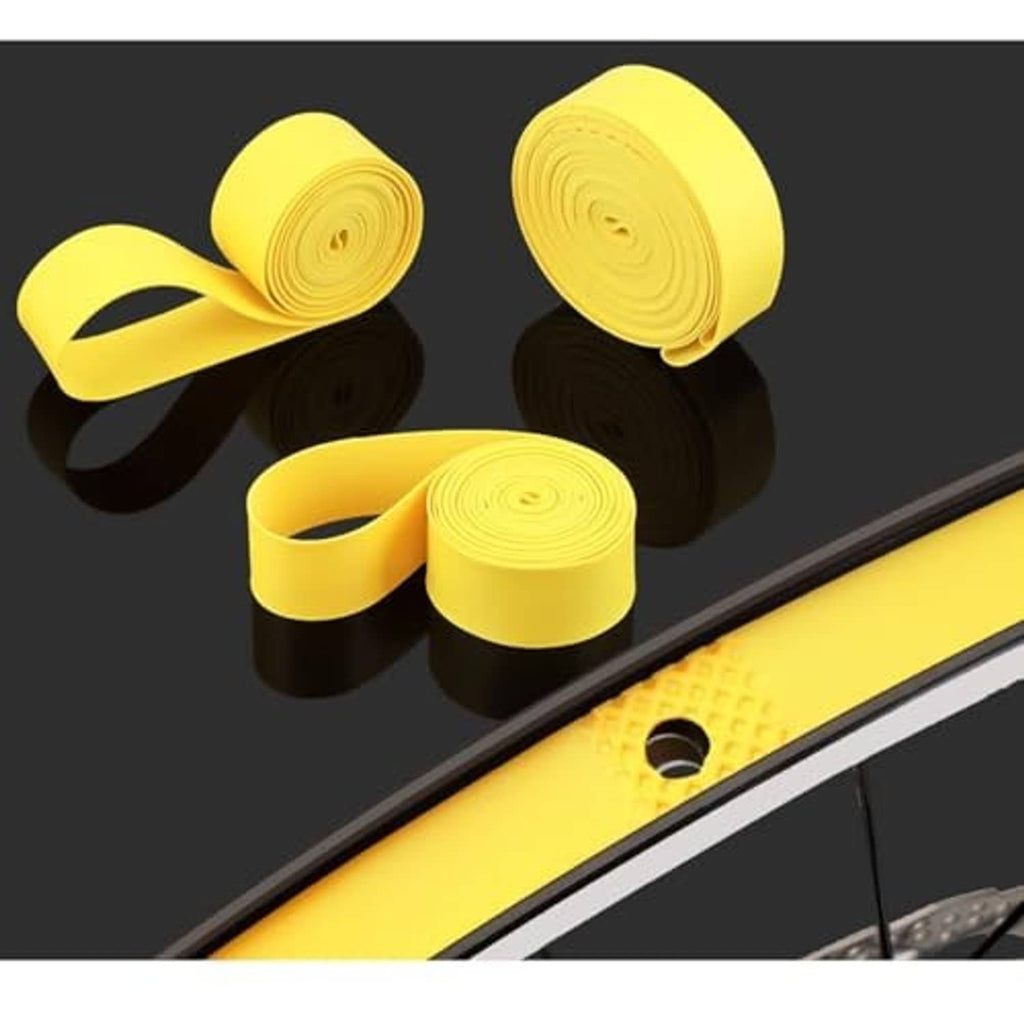 Yellow puncture protection tape strips wrapped around bicycle rim and tire