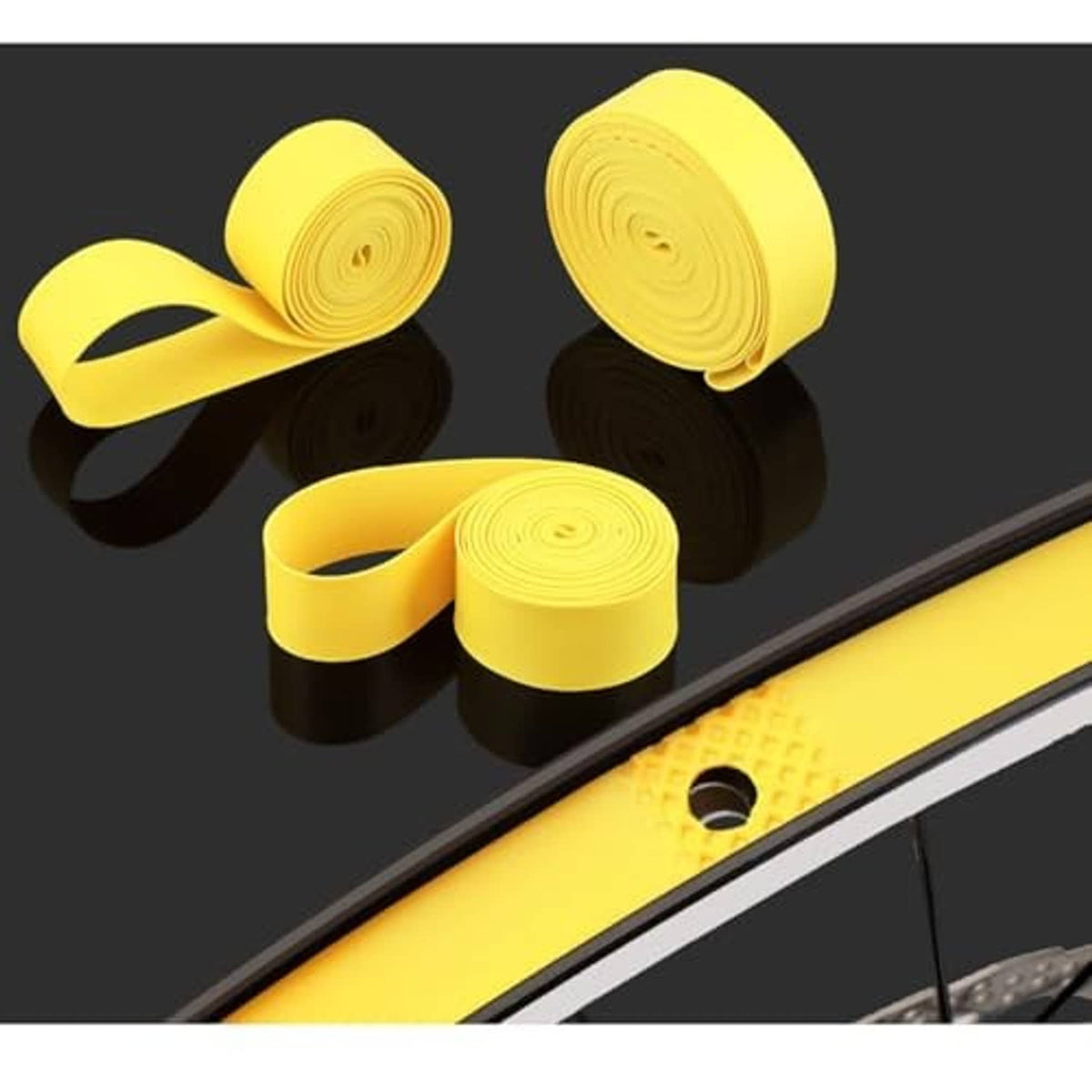 Yellow puncture protection tape strips wrapped around bicycle rim and tire