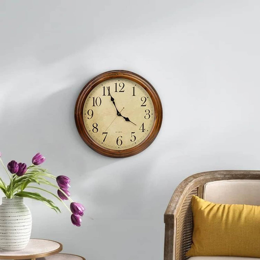 Wood wall clock on wall with cream dial, large Arabic numerals and black hands