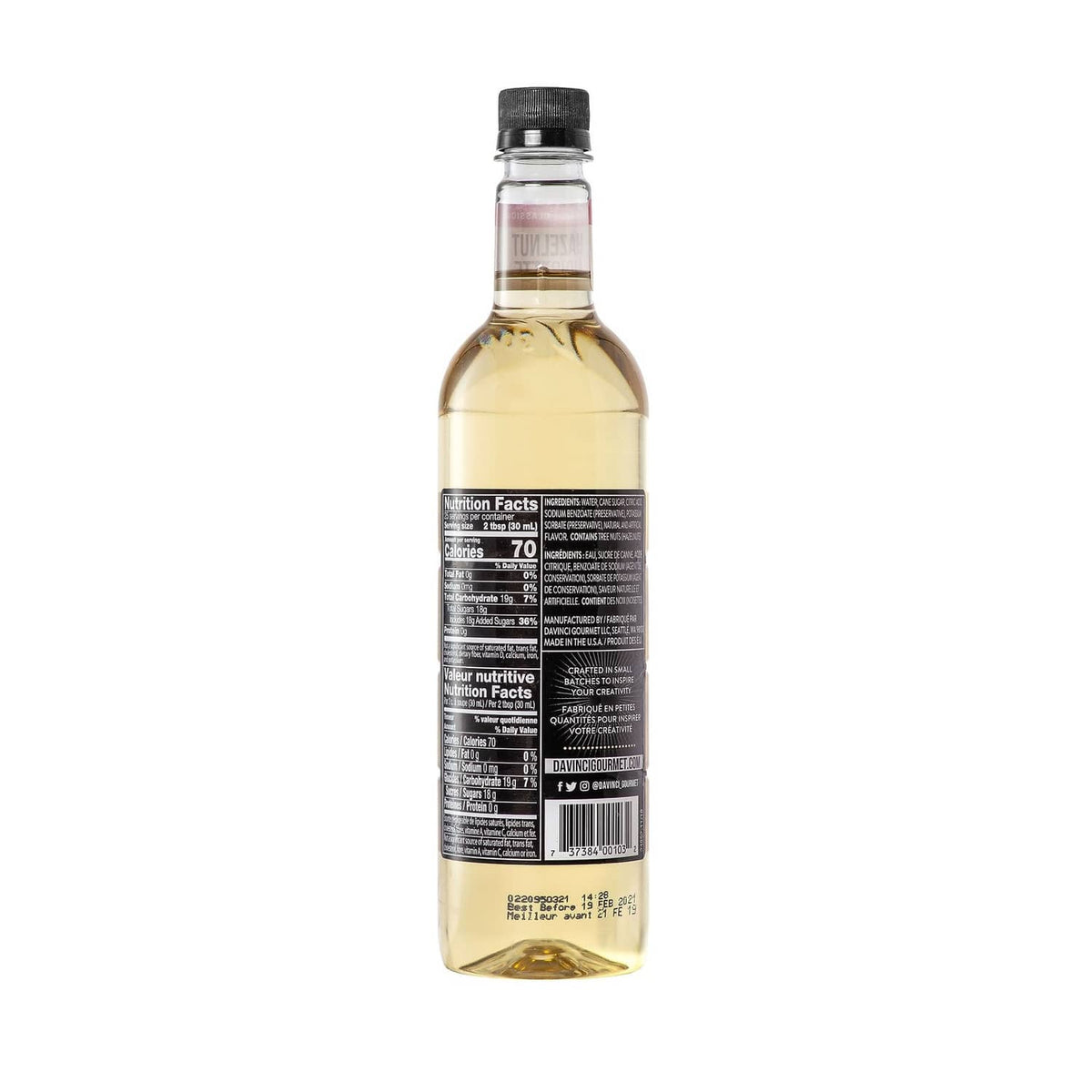 Hazelnut syrup bottle with black cap and amber liquid, label facing camera