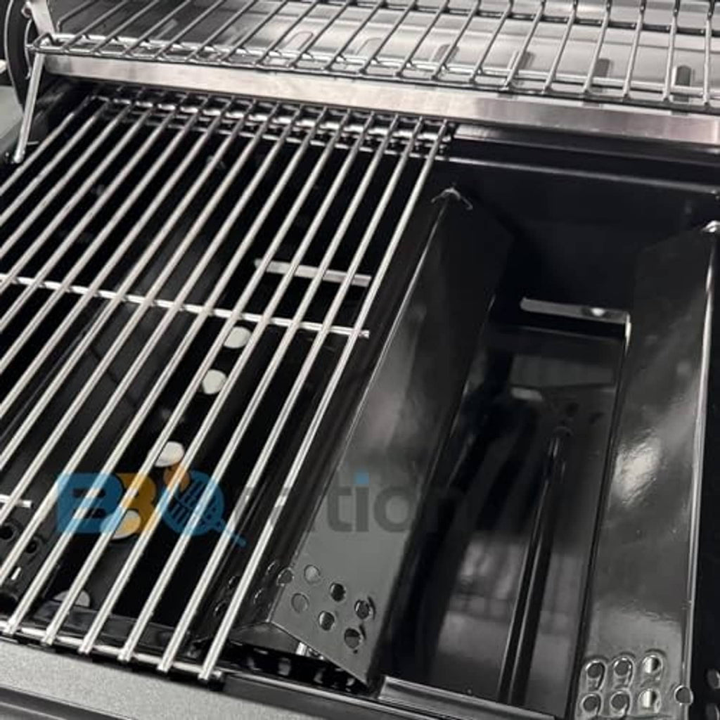 Close-up of stainless grill grates over black burner tray and burner elements