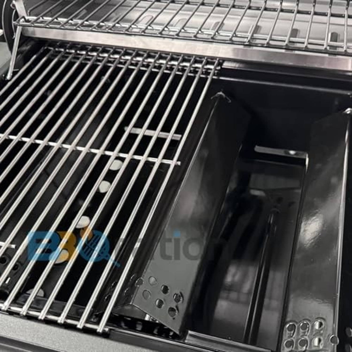 Close-up of stainless grill grates over black burner tray and burner elements