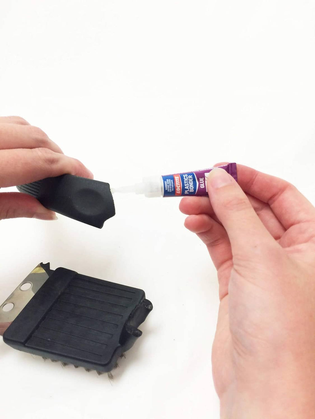 Loctite Plastics bonding system glue applicator with black nozzle