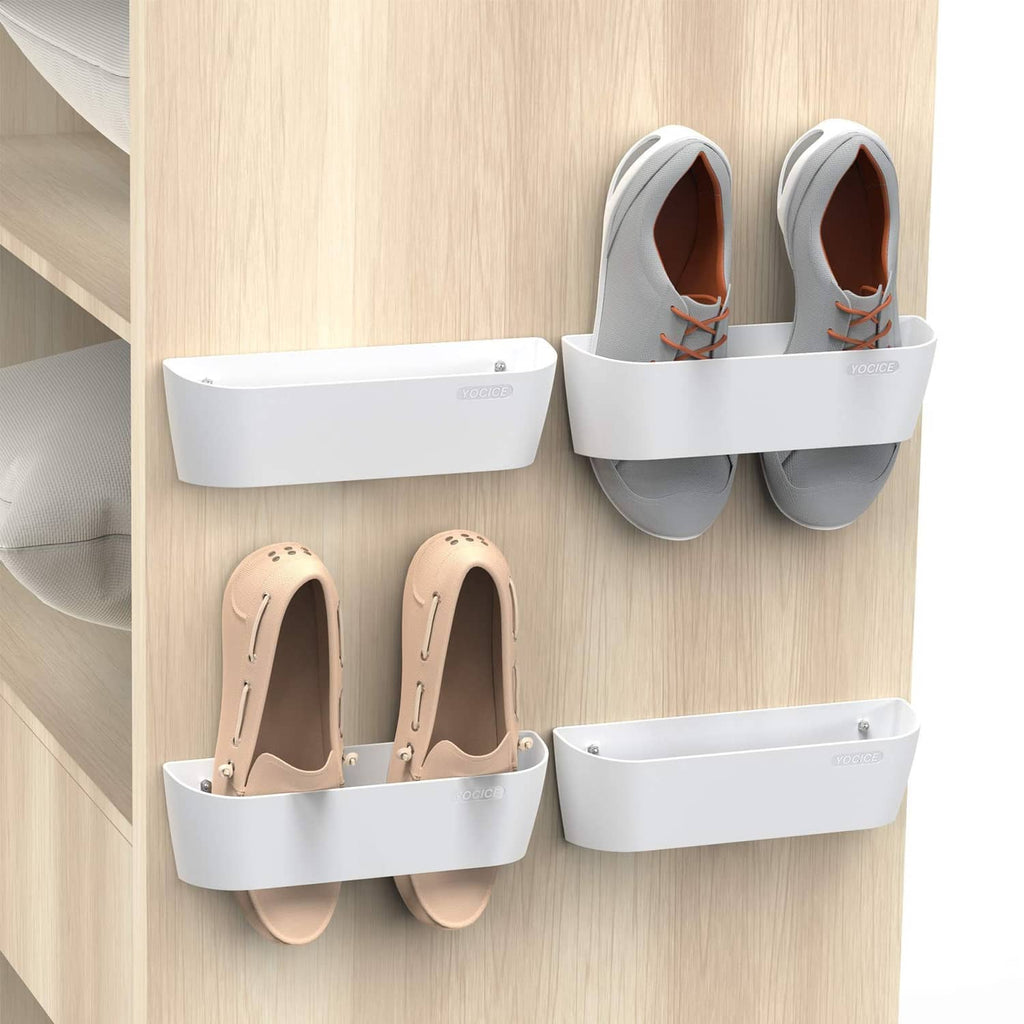 White wall-mounted shoe rack organizer with four separate sections holding shoes