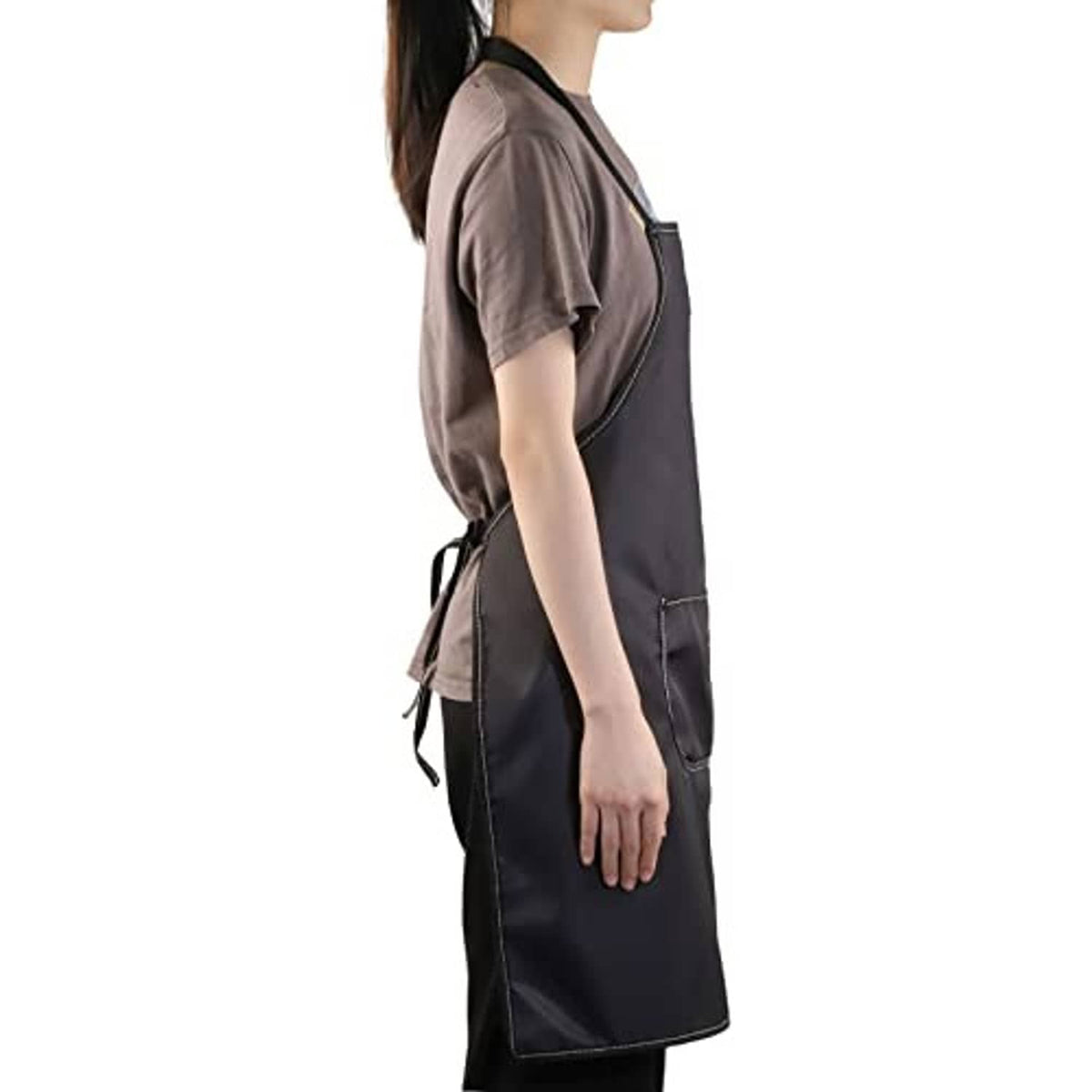 Black apron side view with adjustable straps and waist tie, front pocket detail visible.