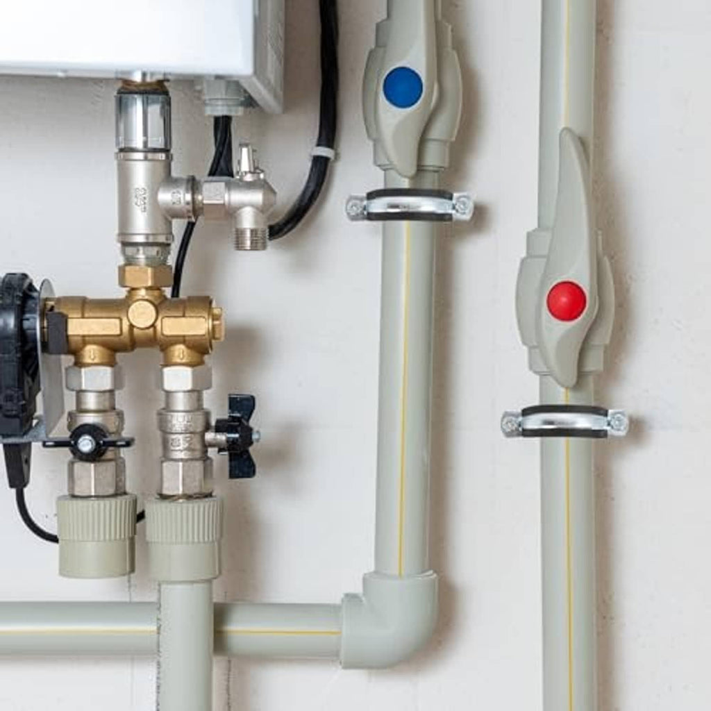 Pipe bracket clamp securing a pipe to a wall-mounted bracket plate