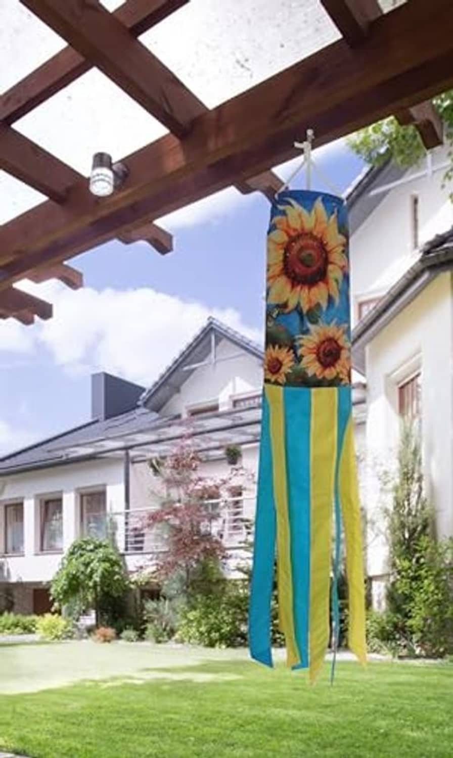 Sunflower windsock hanging with long blue-and-yellow striped ribbon streamers