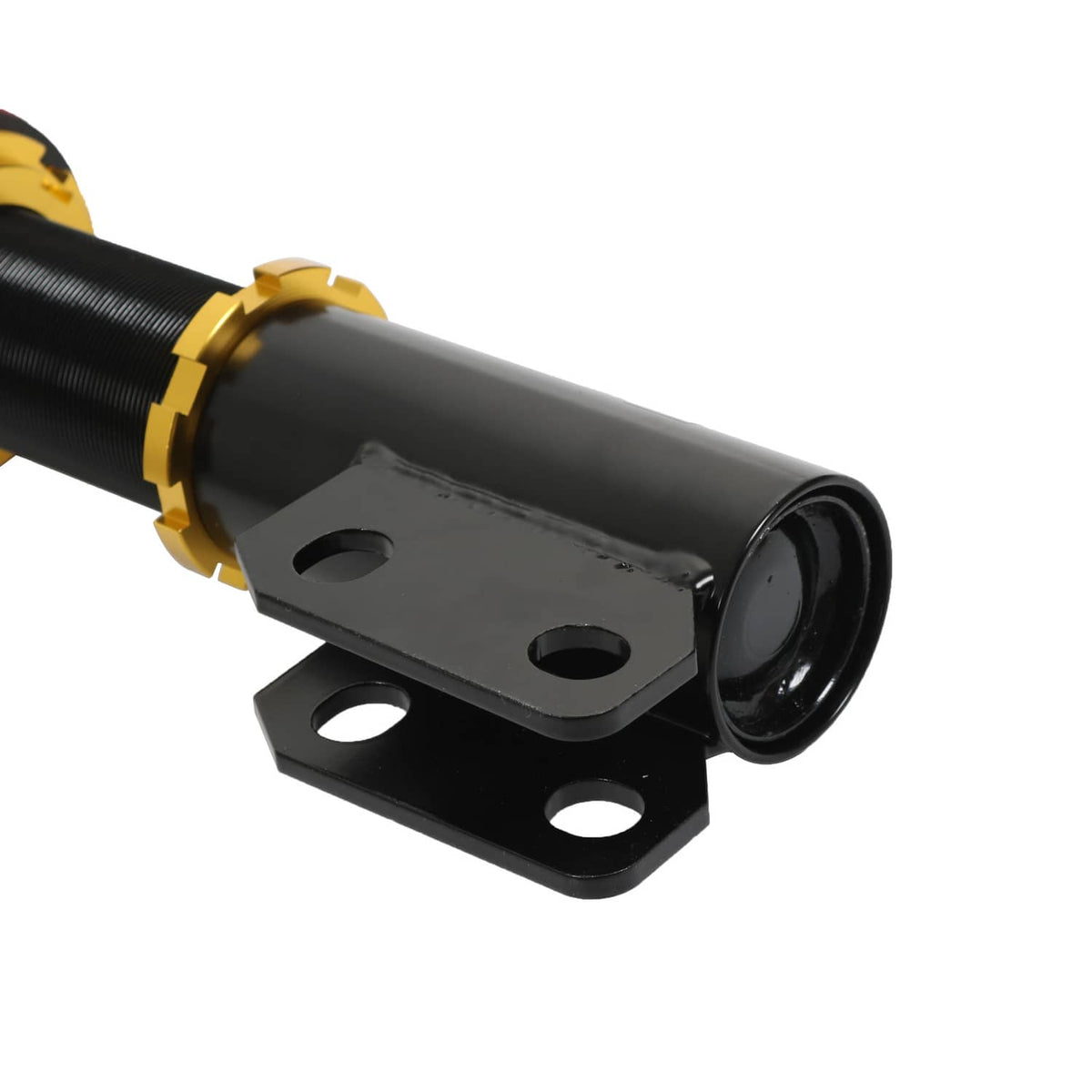 Close-up of coilover strut lower mount and black shock body with gold collar