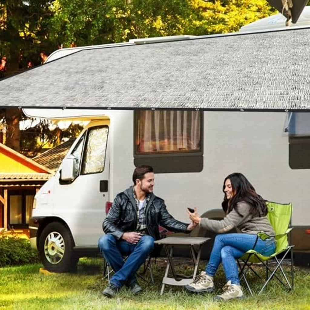 Gray mesh shade cloth canopy over a small van with black grommet edges