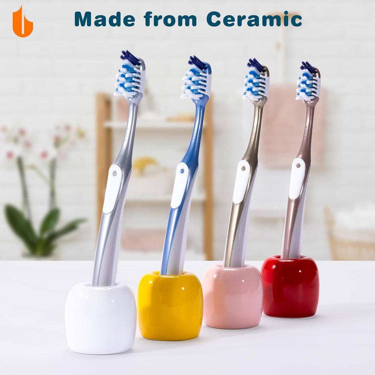 Ceramic toothbrush holder set with four upright toothbrushes in colorful cups.