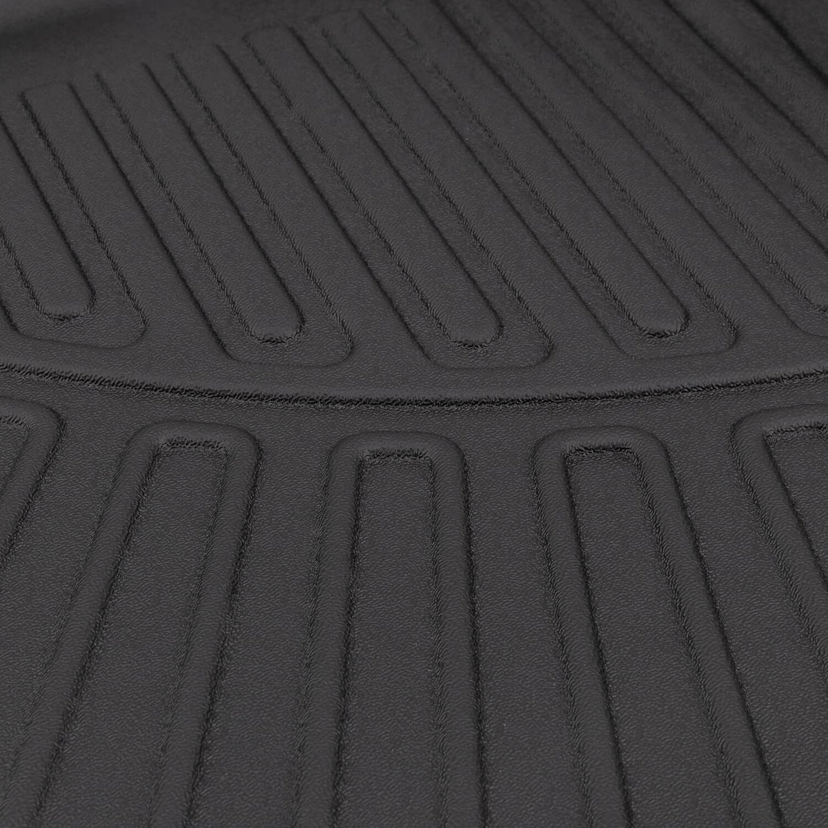 Close-up of black cargo liner mat surface with deep traction grooves