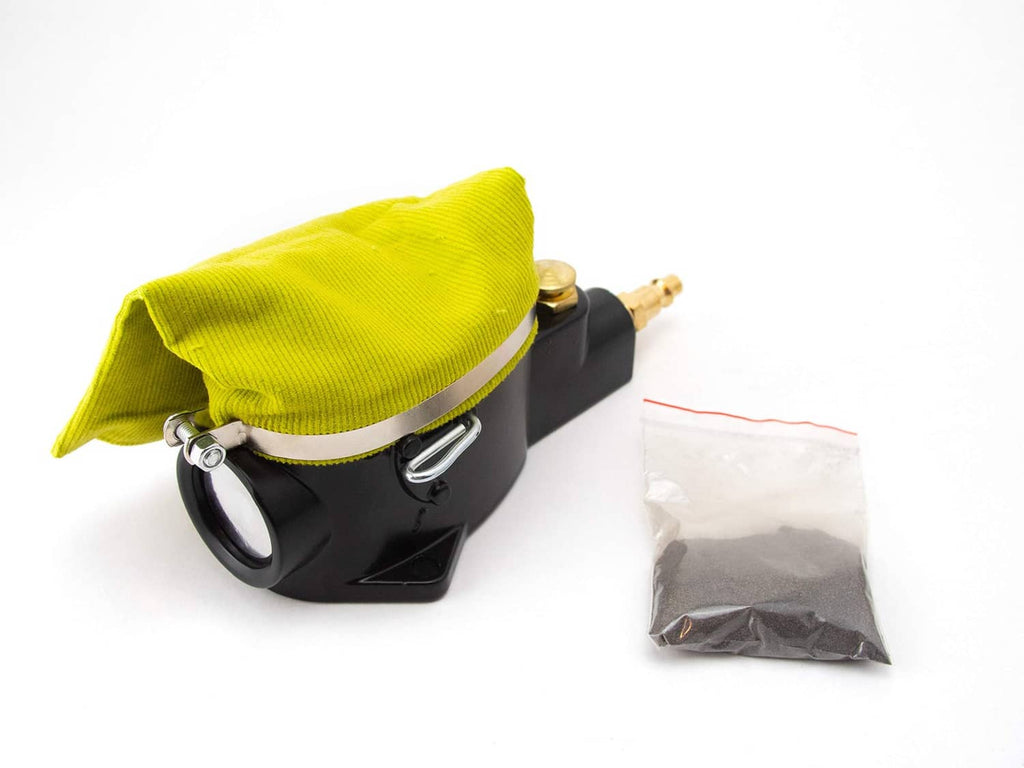 Pneumatic air spark plug cleaner tool with black body and lime cloth sandbag