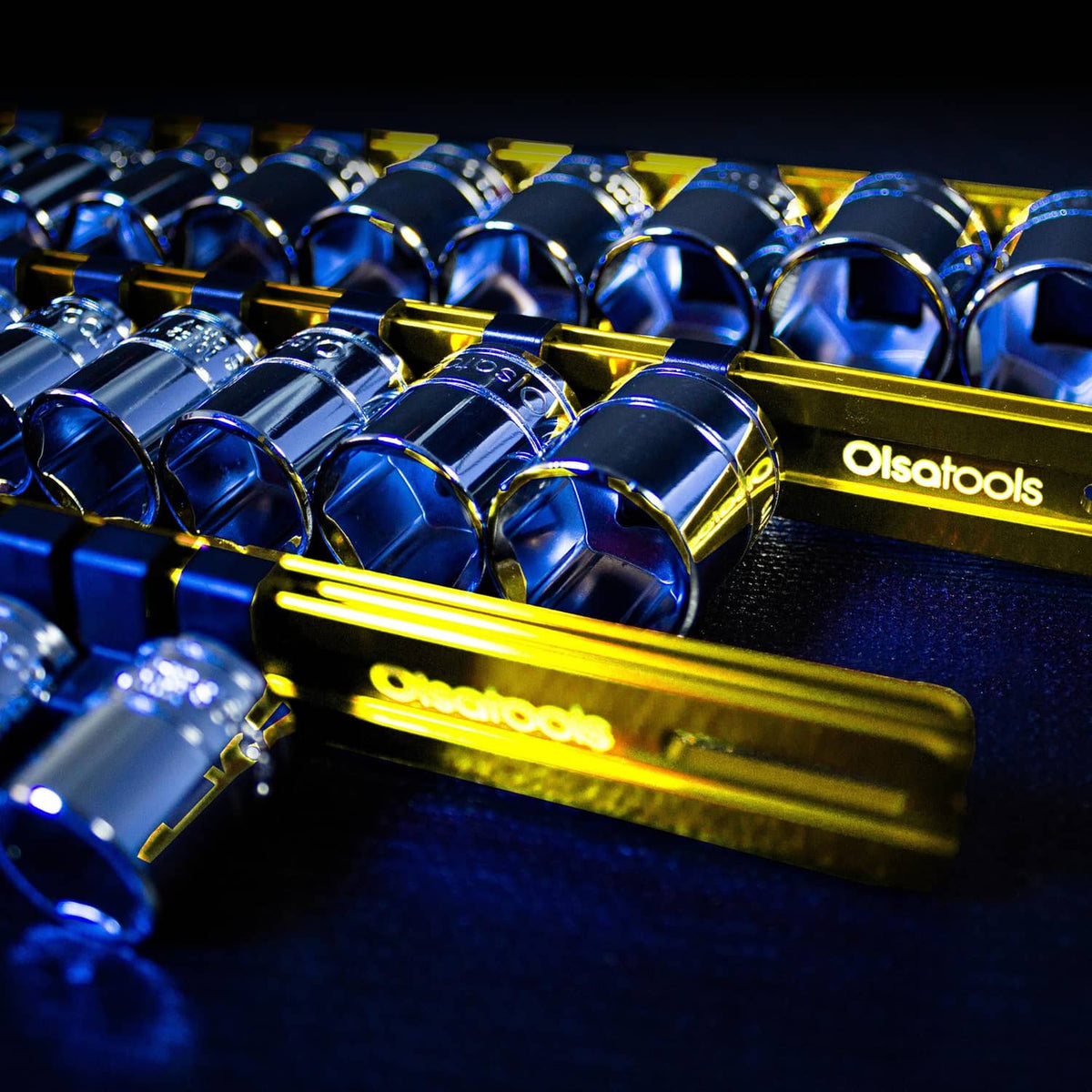 Close-up of chrome sockets on a yellow socket organizer rail with clips