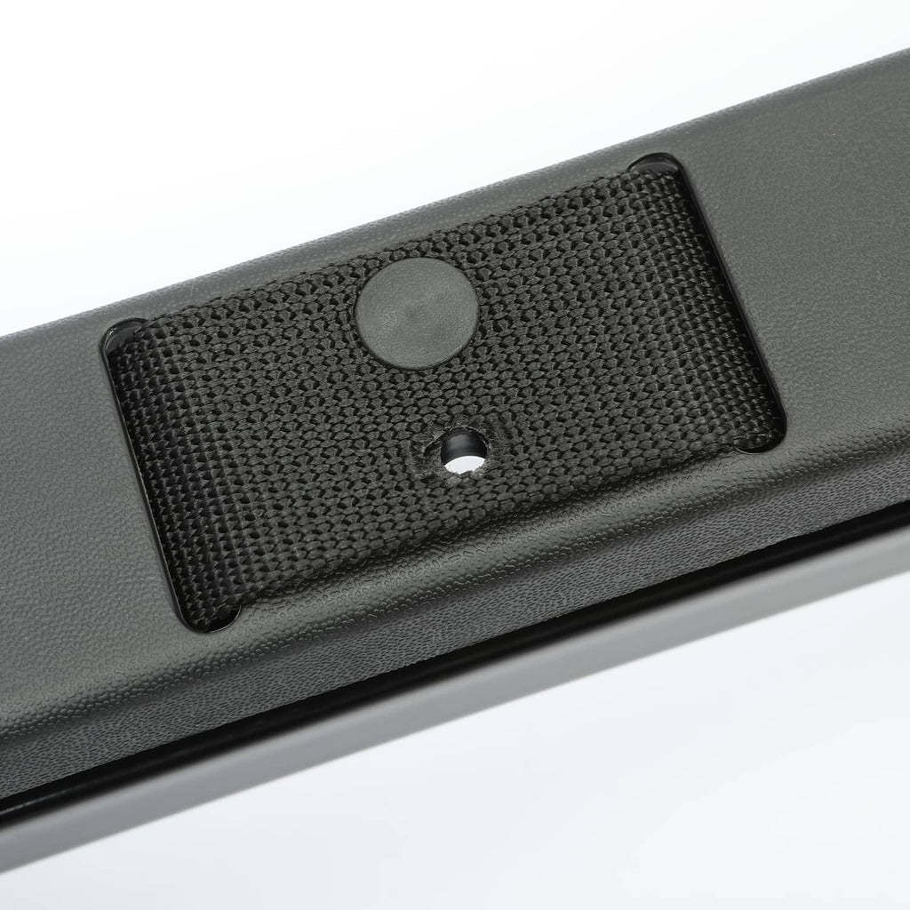 Close-up of black textured mounting pad with round screw hole on bracket bar