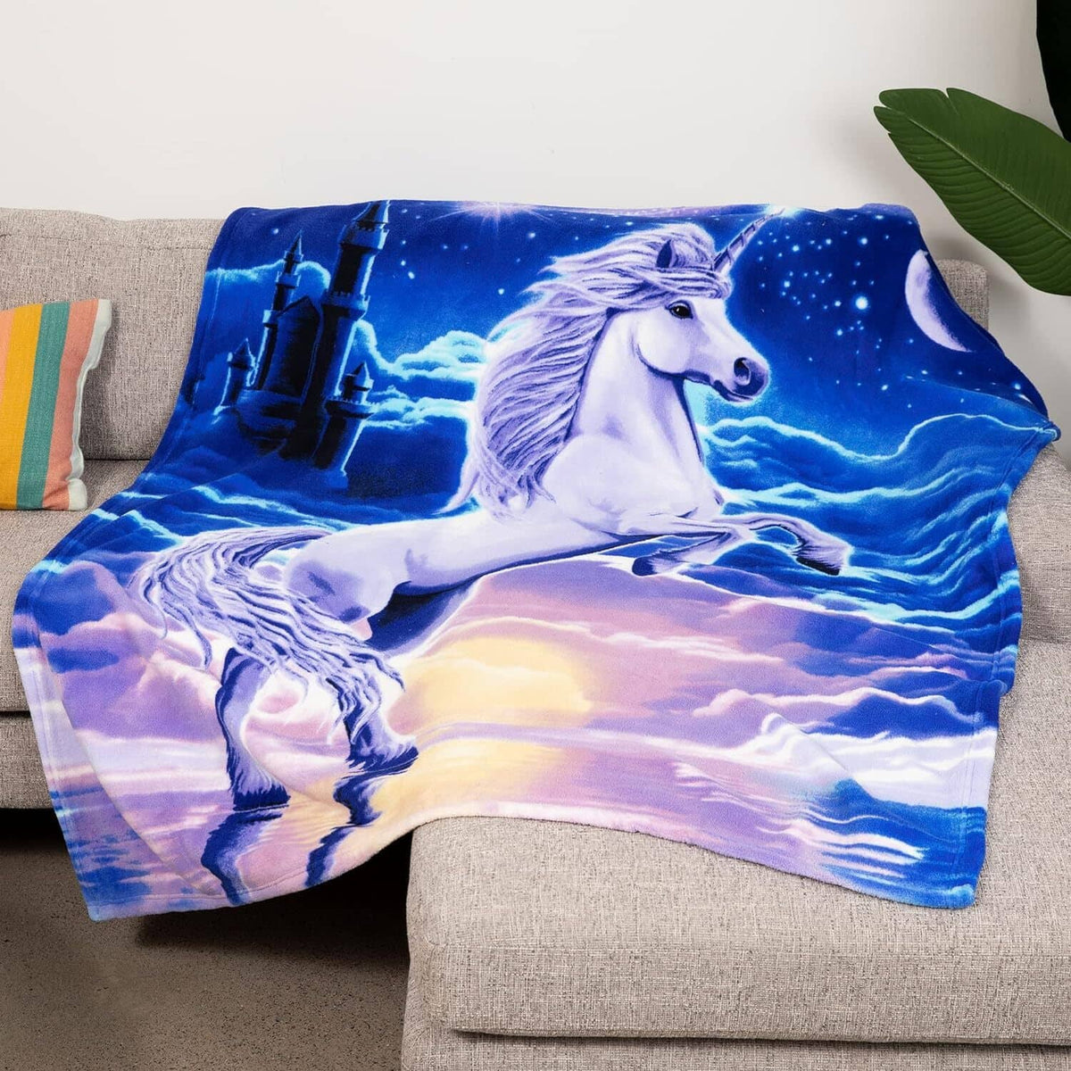 Unicorn-themed plush fleece blanket, blue with white unicorn in starry night scene