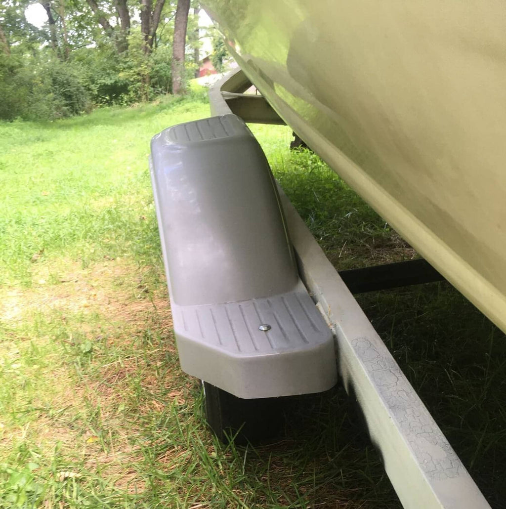 Gray step fender mounted along trailer side with ribbed tread panel