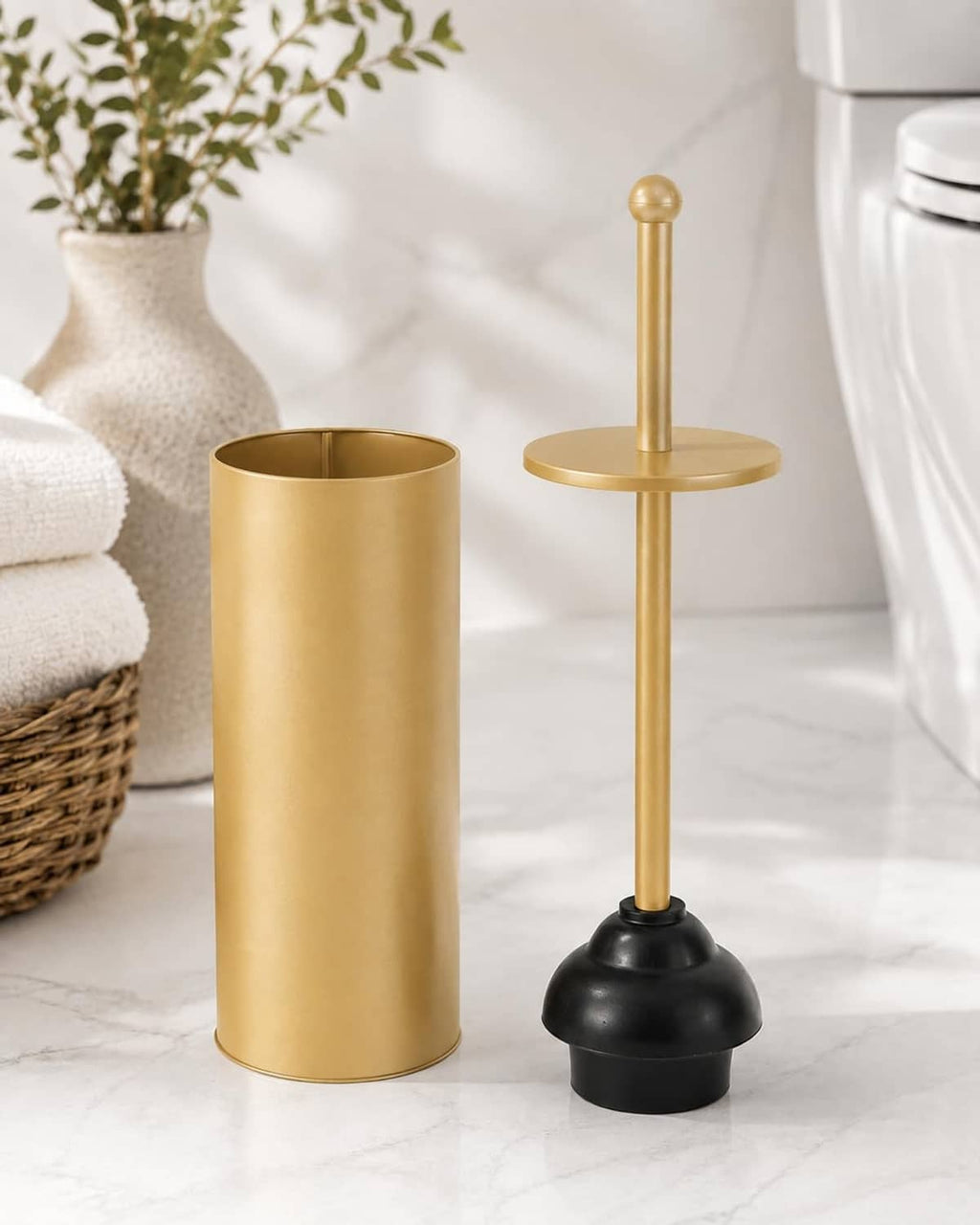 Gold toilet plunger with black cup standing in gold holder, bathroom setting
