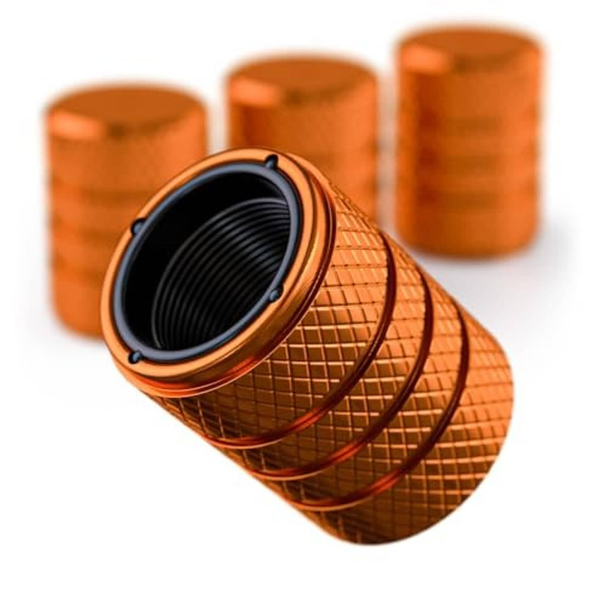 Amber orange tire valve stem caps with black inner seal and ridged textured grip