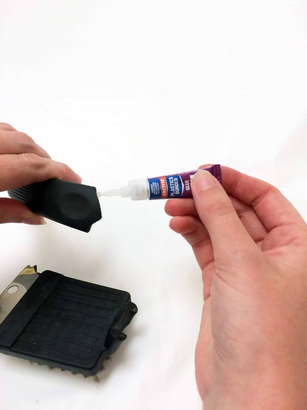 Loctite Plastics bonding system applicator dispensing adhesive to a small part