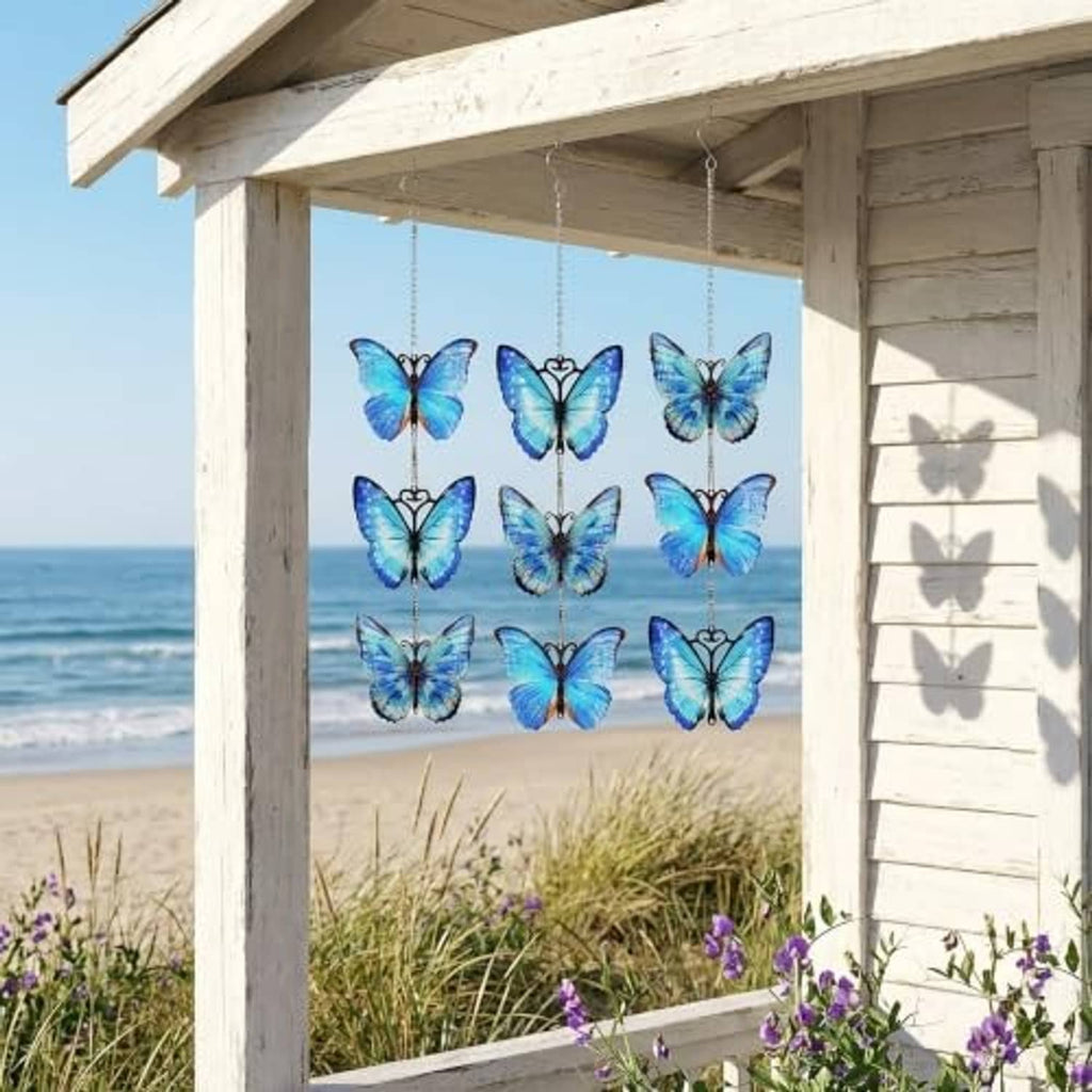 Blue butterfly metal wind spinners with silver hanging chains, outdoor porch display