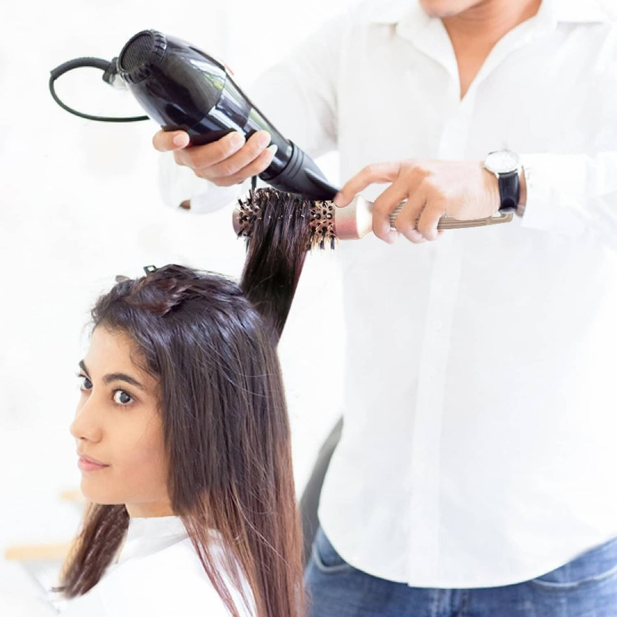 Hair brush used to style dark hair with a gold round vented barrel
