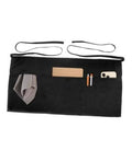 Black apron with four pockets, tan center pocket, adjustable neck and waist straps