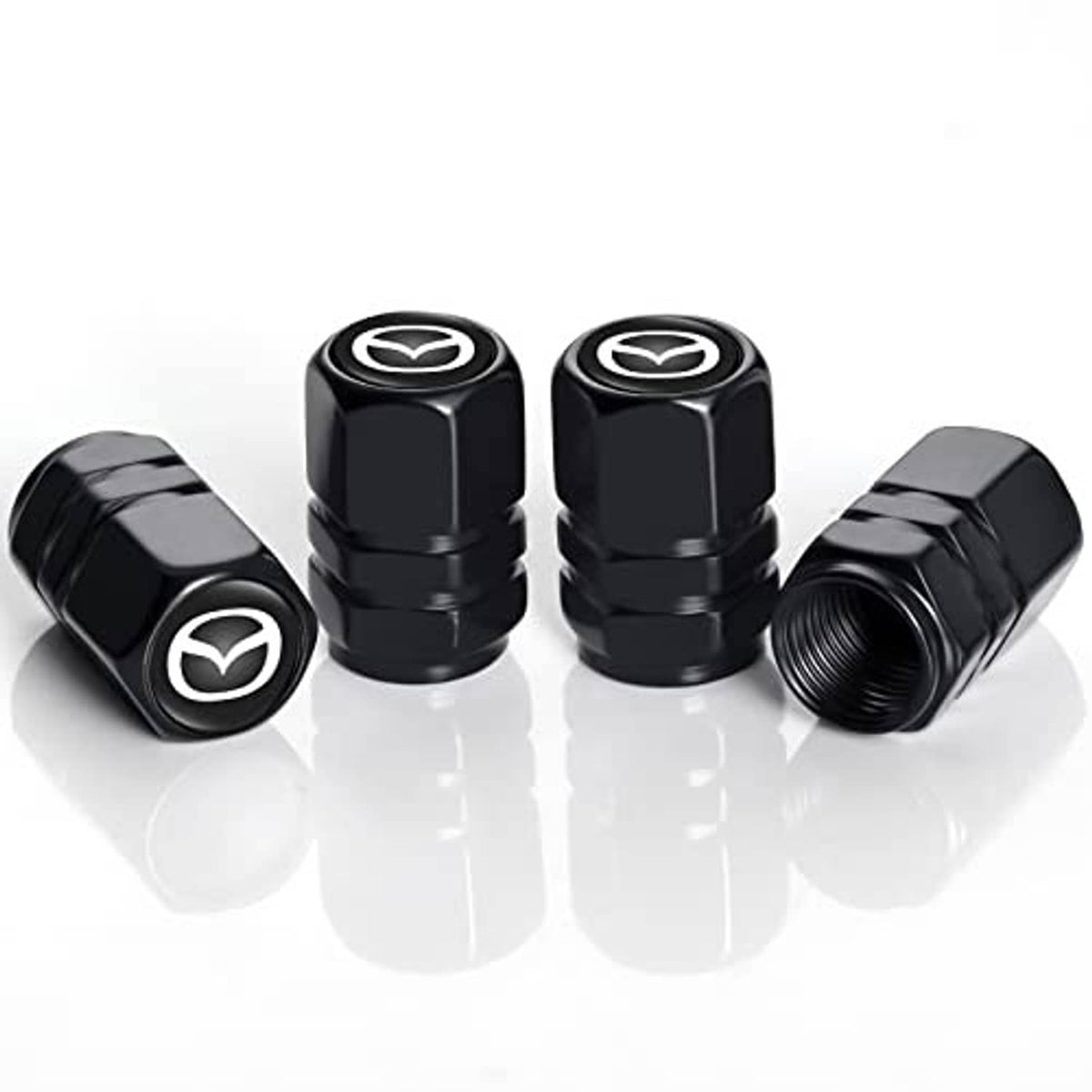 Set of four black metal tire valve stem caps with Mazda emblem, angled front view