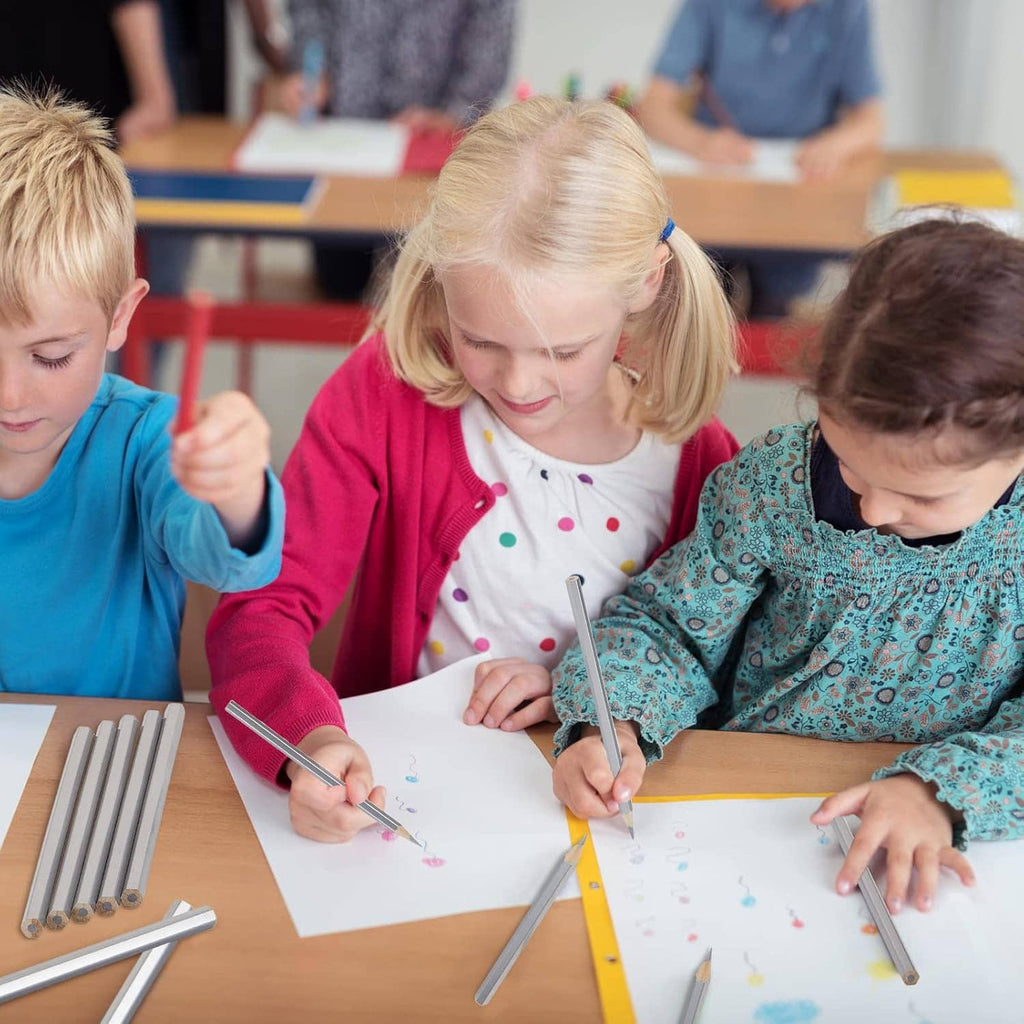 Silver metallic marking pencils used by children drawing on paper.