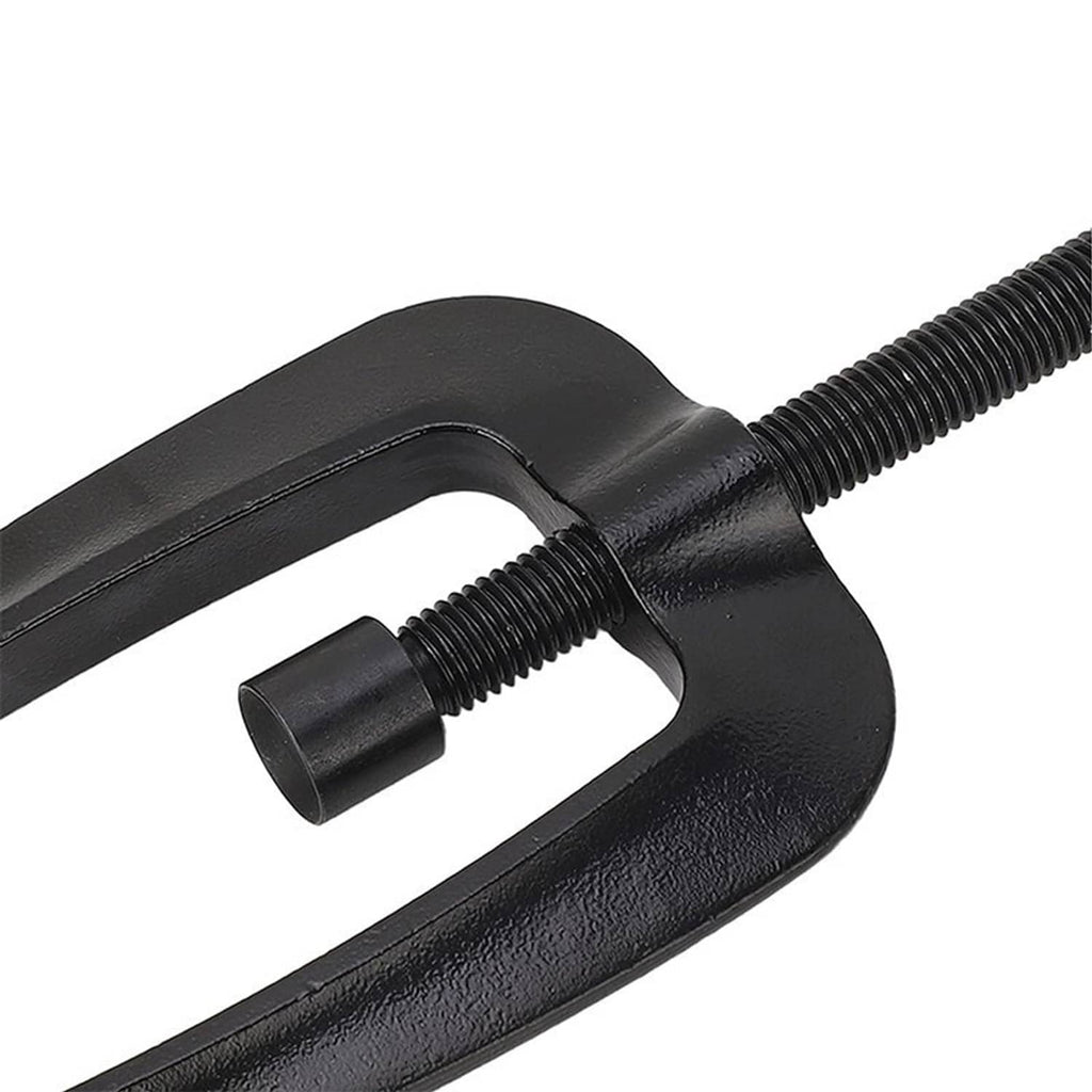 Close-up of black steering support bracket puller jaws and threaded rod connection