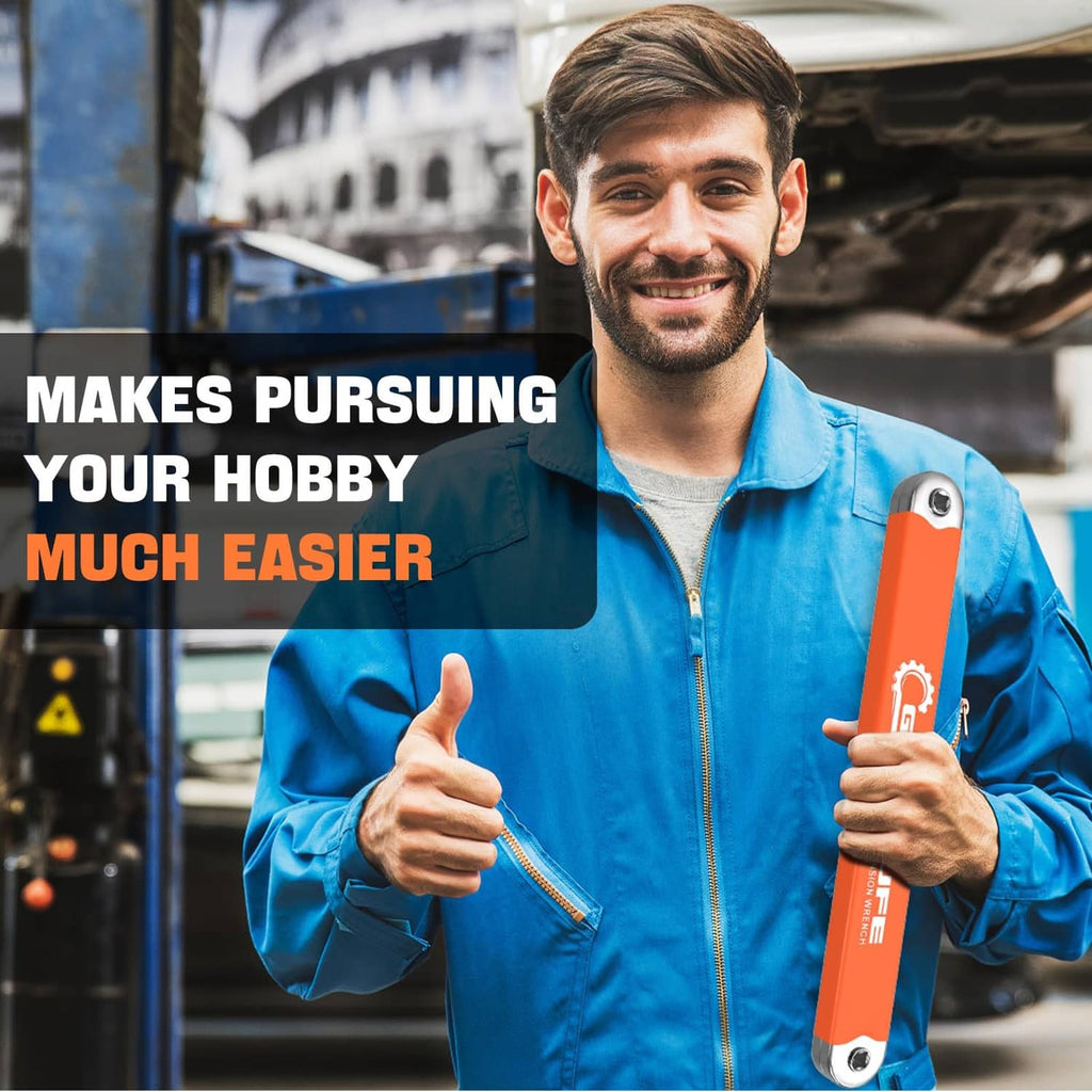 Orange offset extension impact wrench held upright by a person in a workshop.