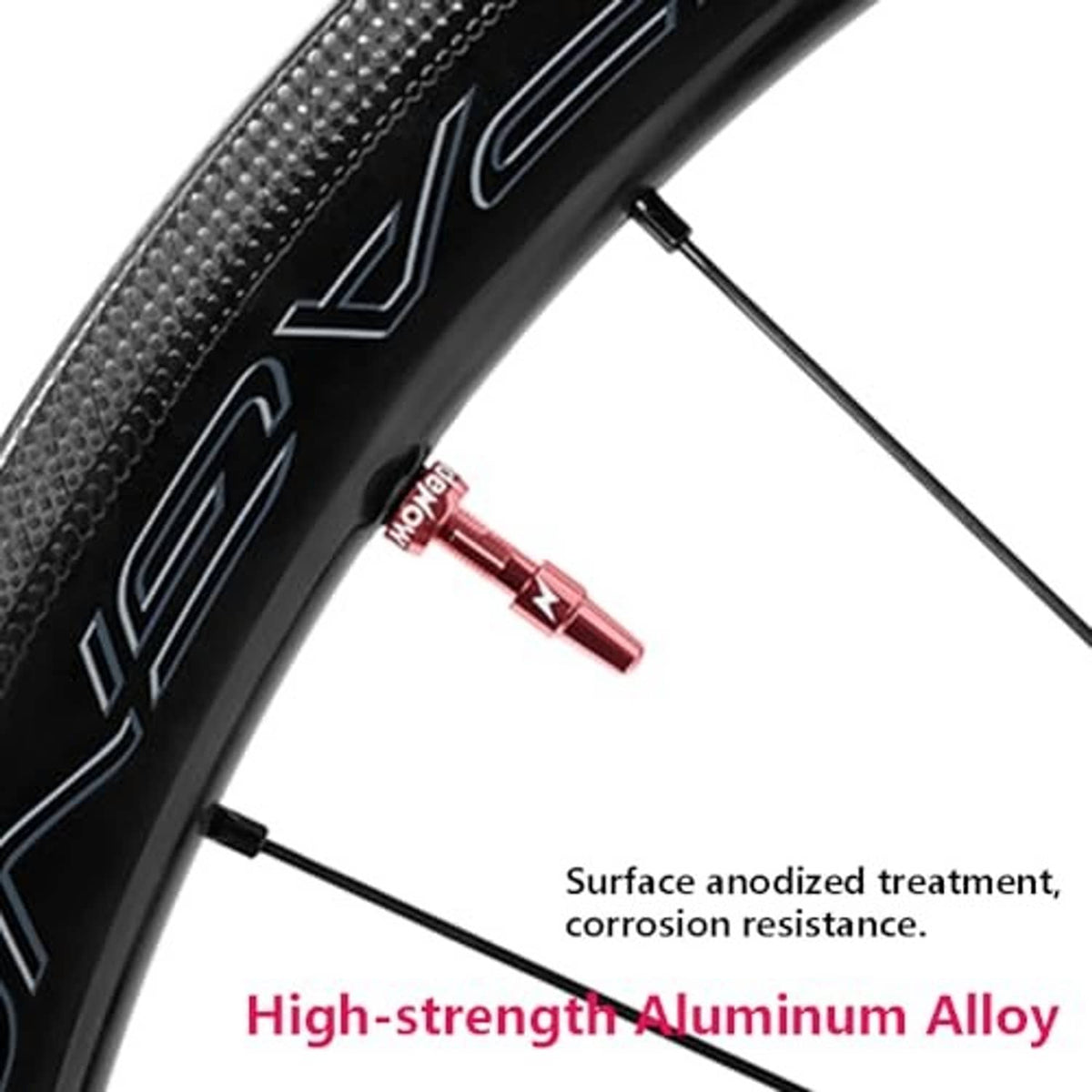 Red Presta tubeless valve installed on black tire sidewall