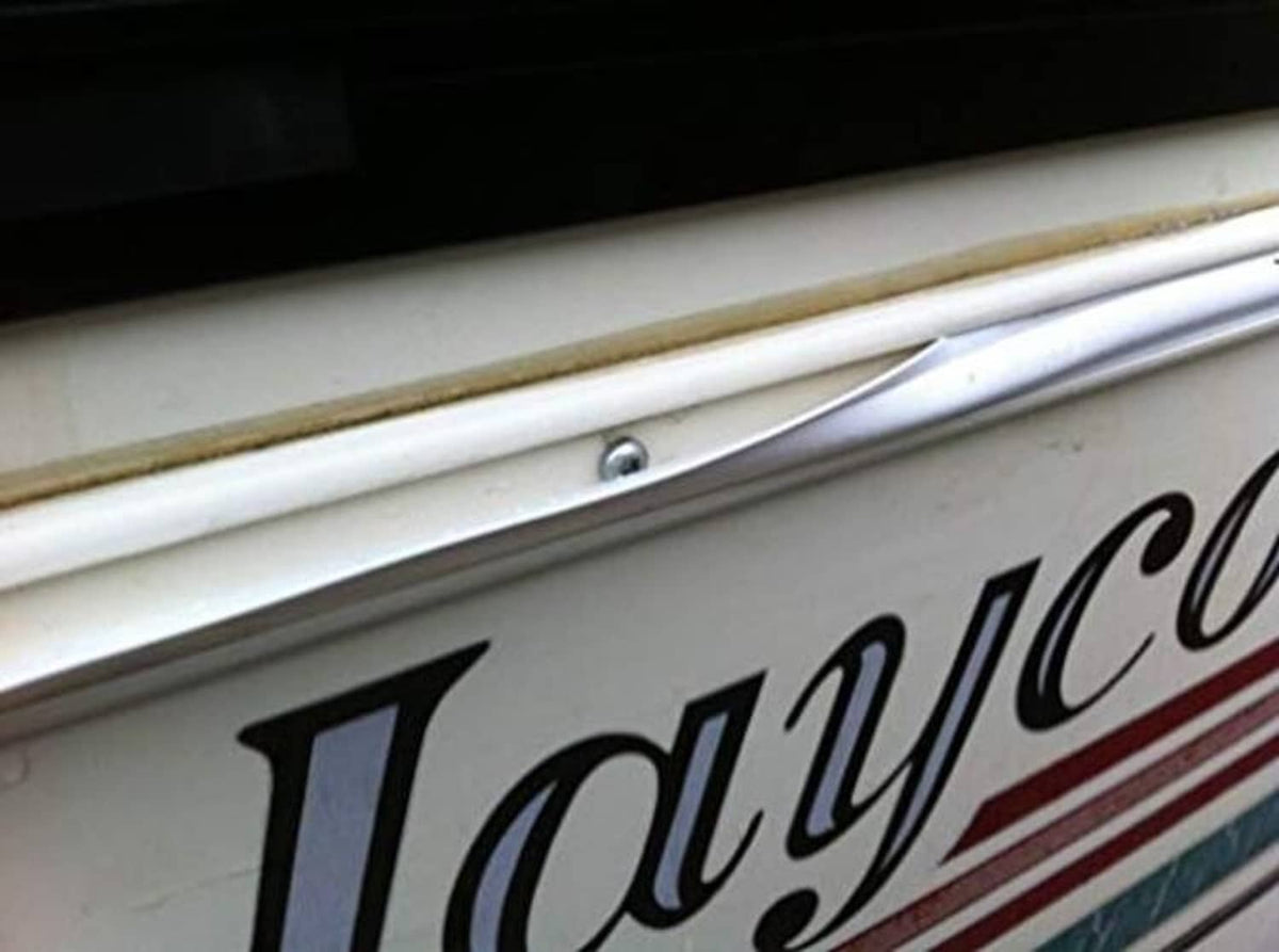 Light tan vinyl trim installed along a vehicle body edge