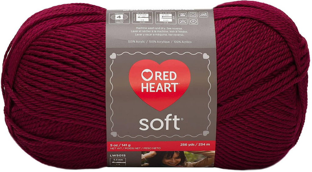 Red Heart Soft yarn skein in wine color, shown in original label packaging