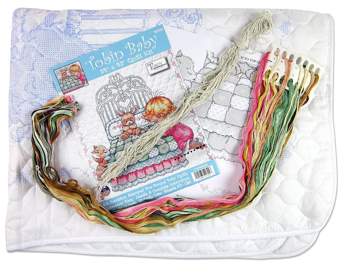 Stamped baby quilt kit with embroidery floss skeins and printed cross-stitch pattern