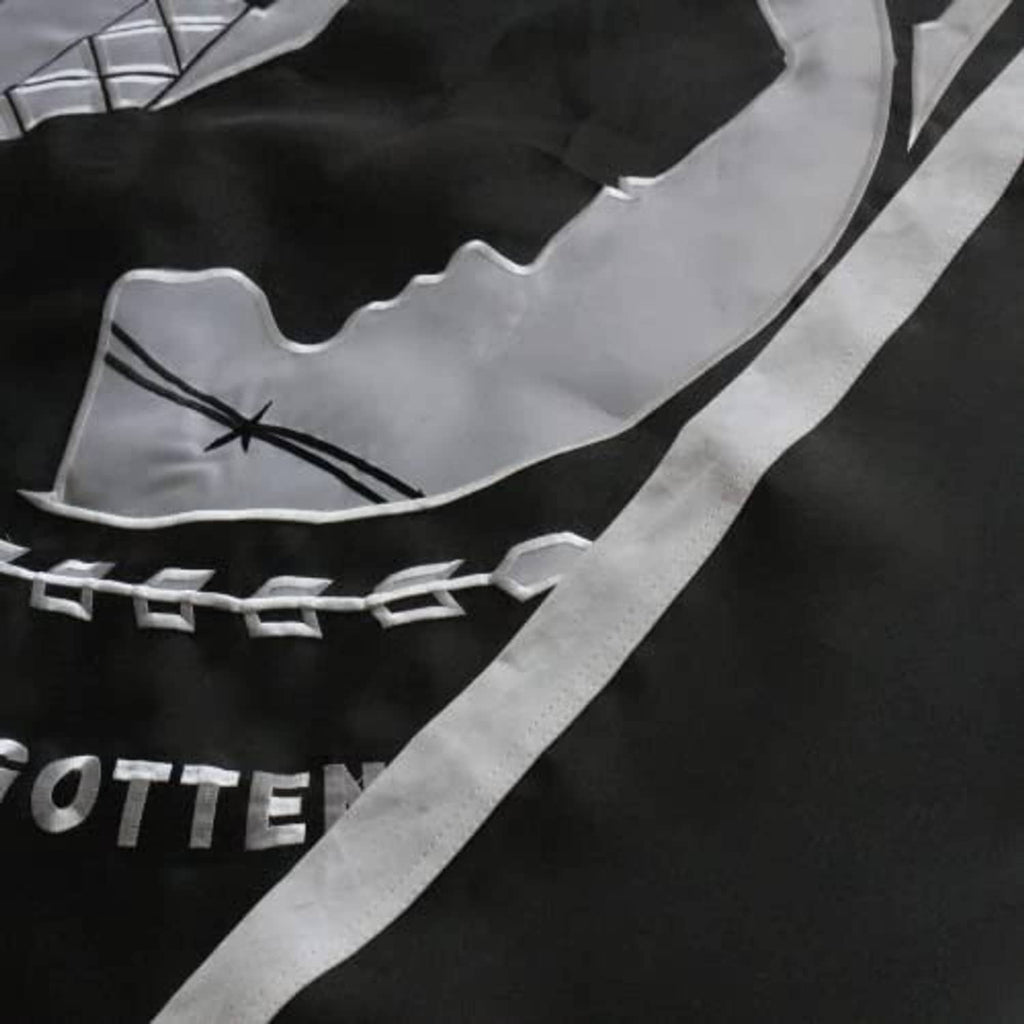 Close-up of POW*MIA flag embroidery with gray portrait silhouette and chain border