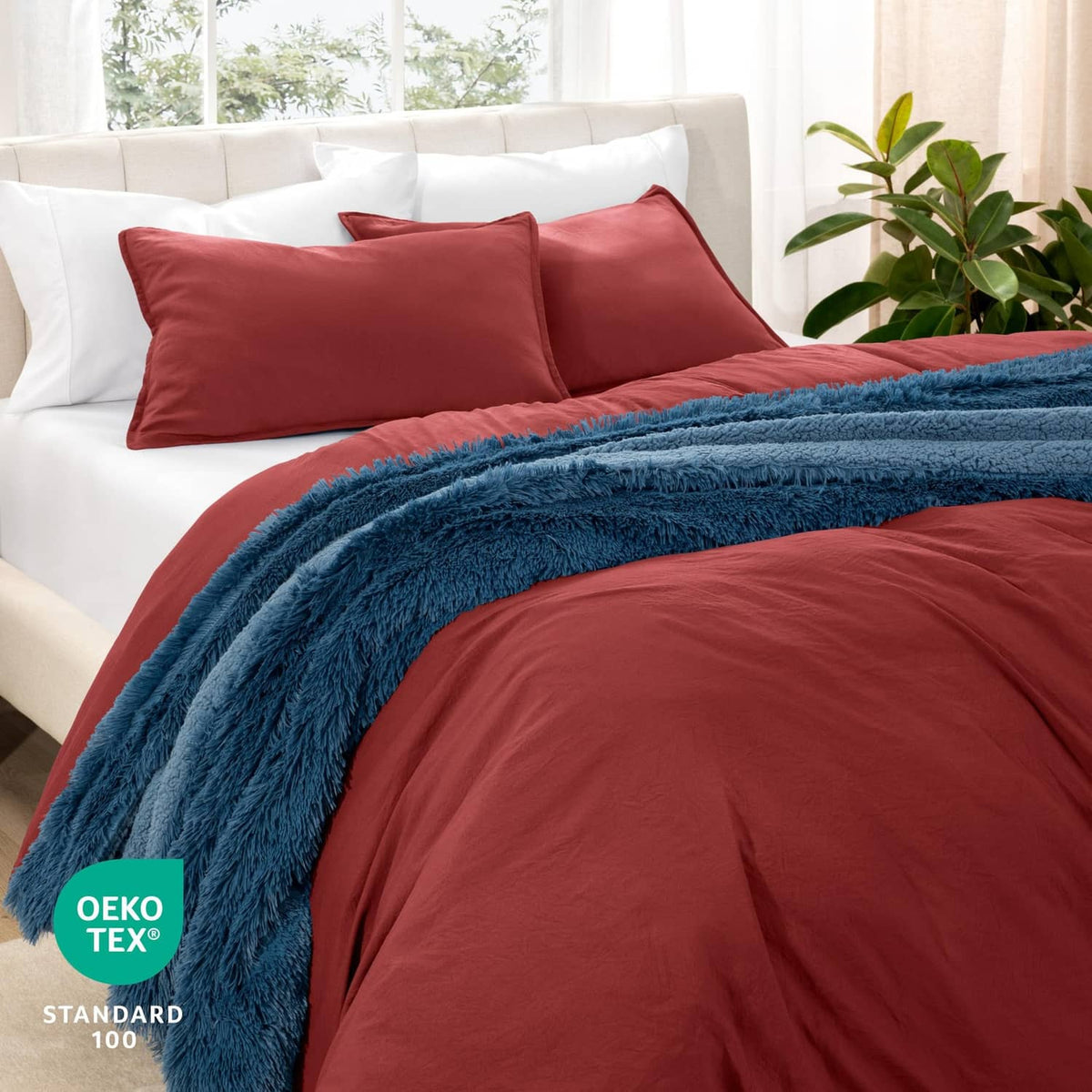Red duvet cover set with two pillow shams, styled with a blue throw