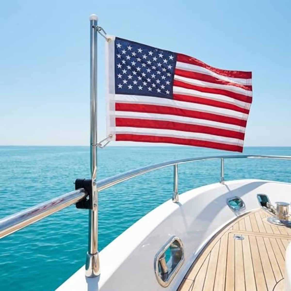 Boat flag on stainless pole with small American flag above deck rail