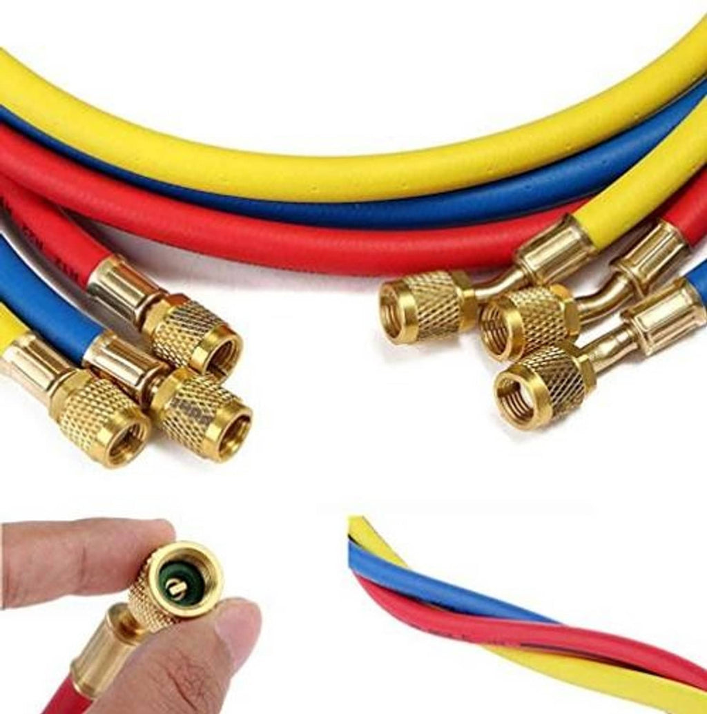Close-up of brass refrigerant hose fittings on blue and red hoses with threaded couplers