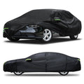 Black custom-fit car cover with green pull tabs, fitted over a sedan front view