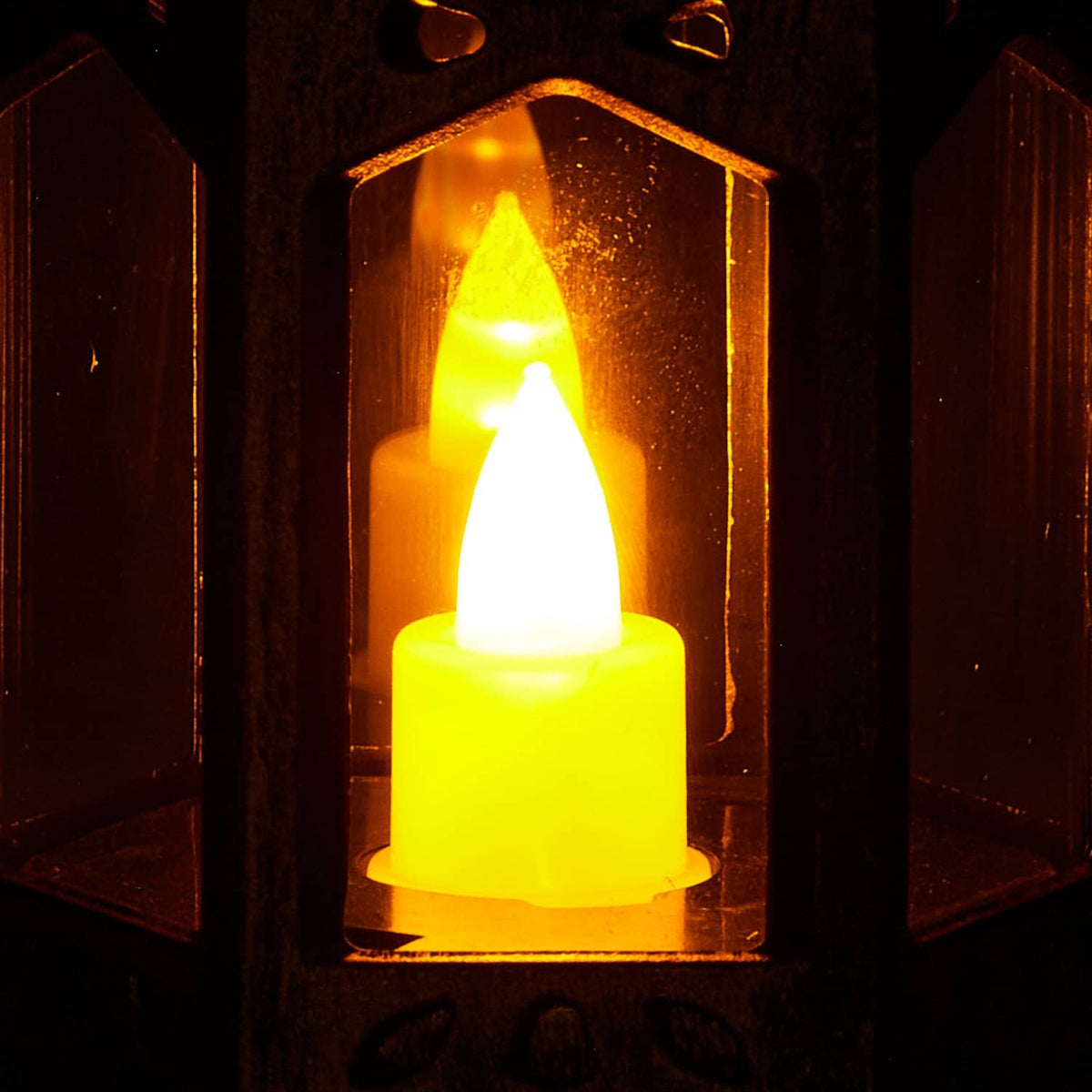 Bronze decorative lantern with LED flameless candle inside, warm flickering glow
