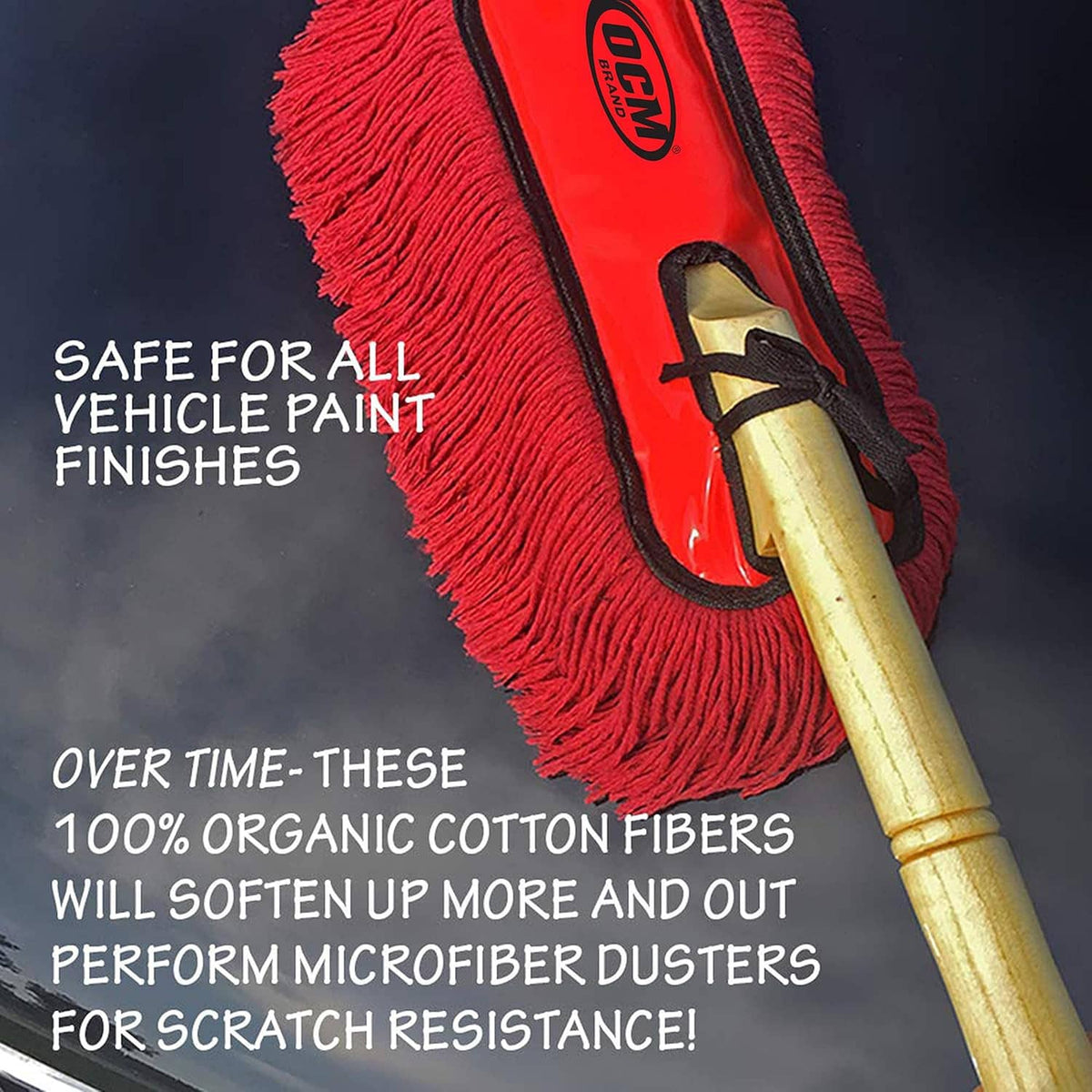 Close-up of red fringe car duster with black trim and wooden handle