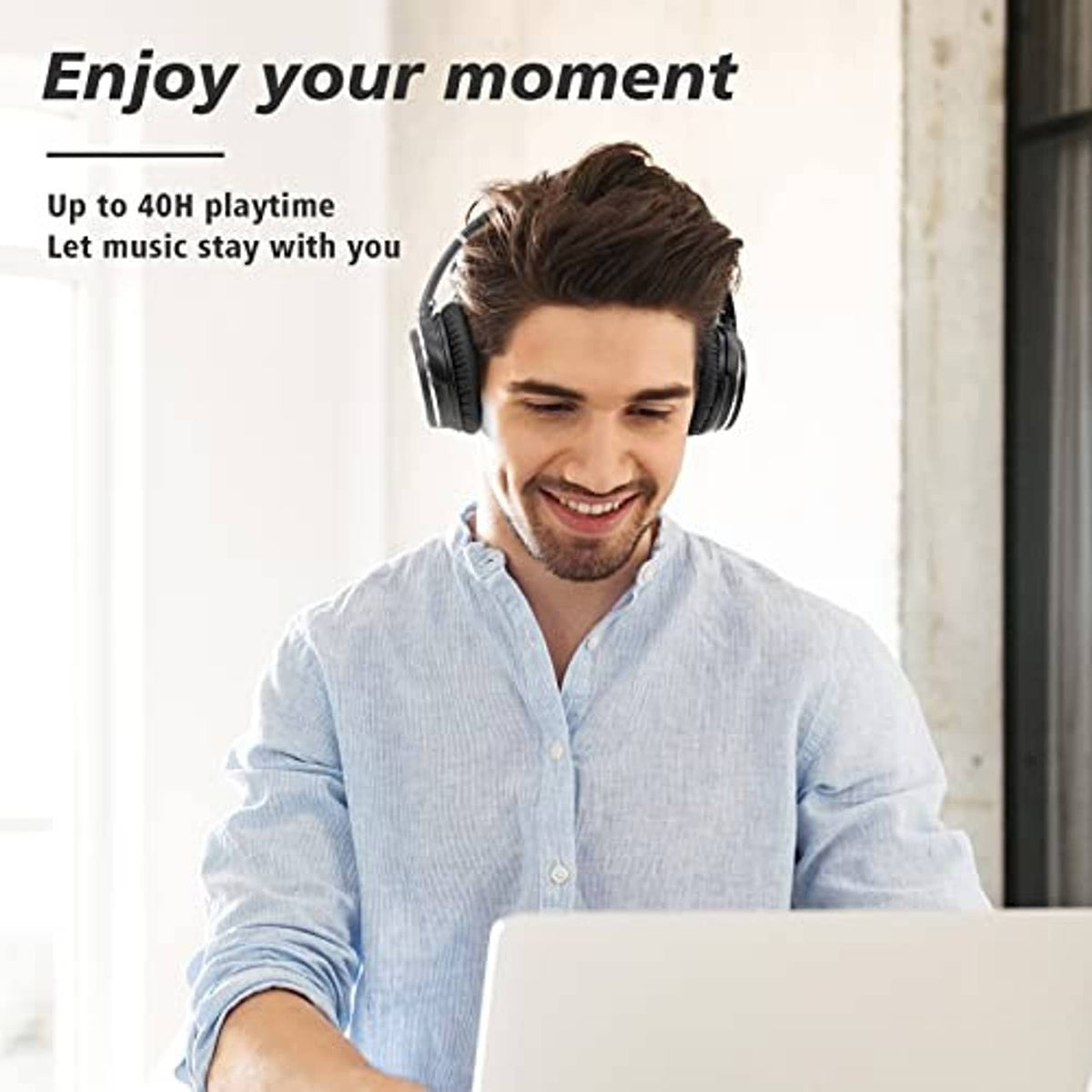 Over-ear black headphones worn by a man with padded ear cups and headband