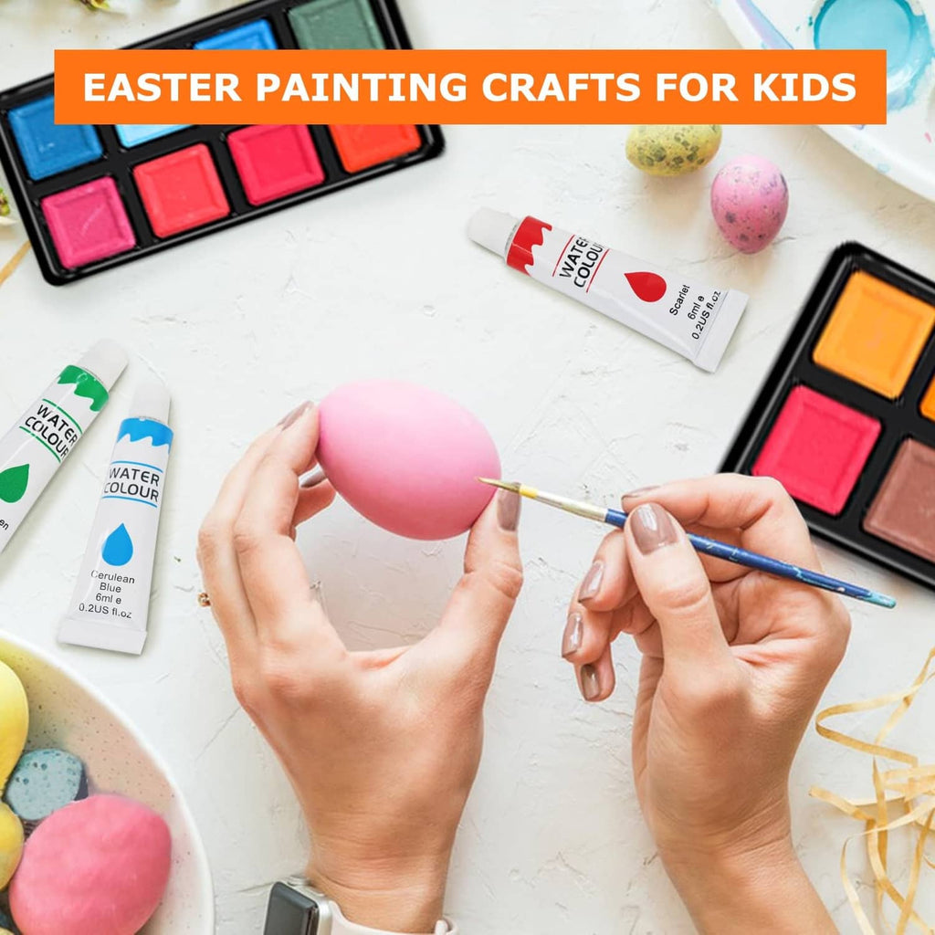 Paintbrush painting a decorated pink Easter egg on a craft table