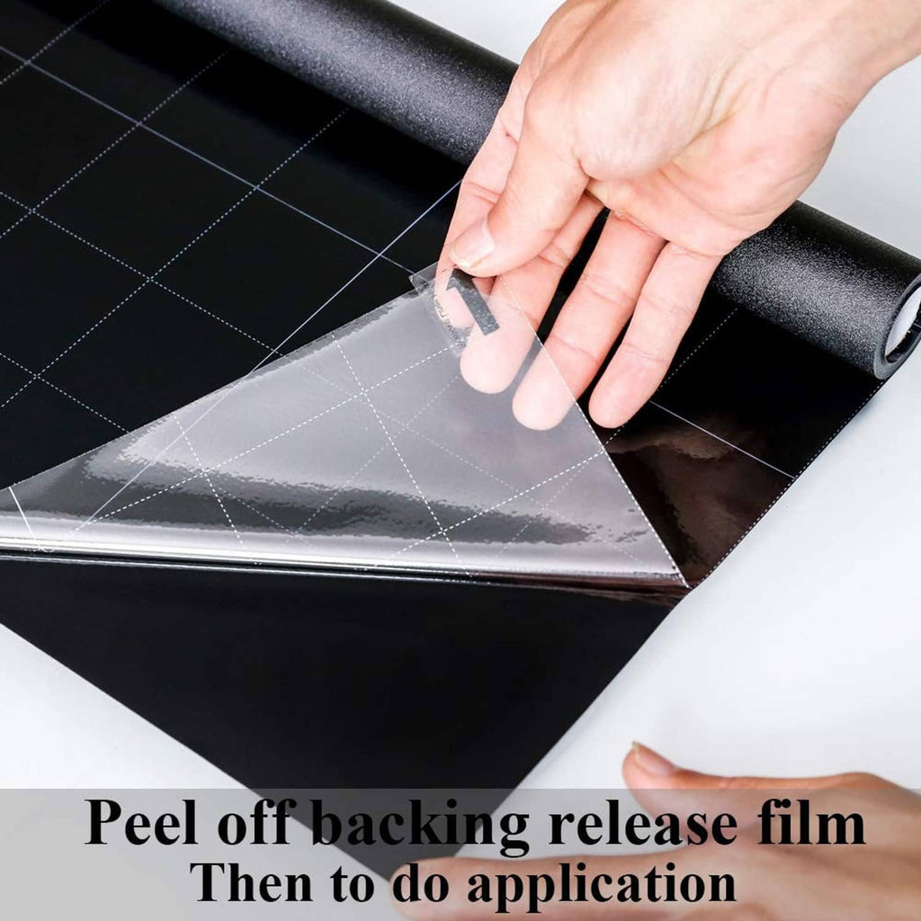Blackout window film being applied by hand, peel-and-stick back release film